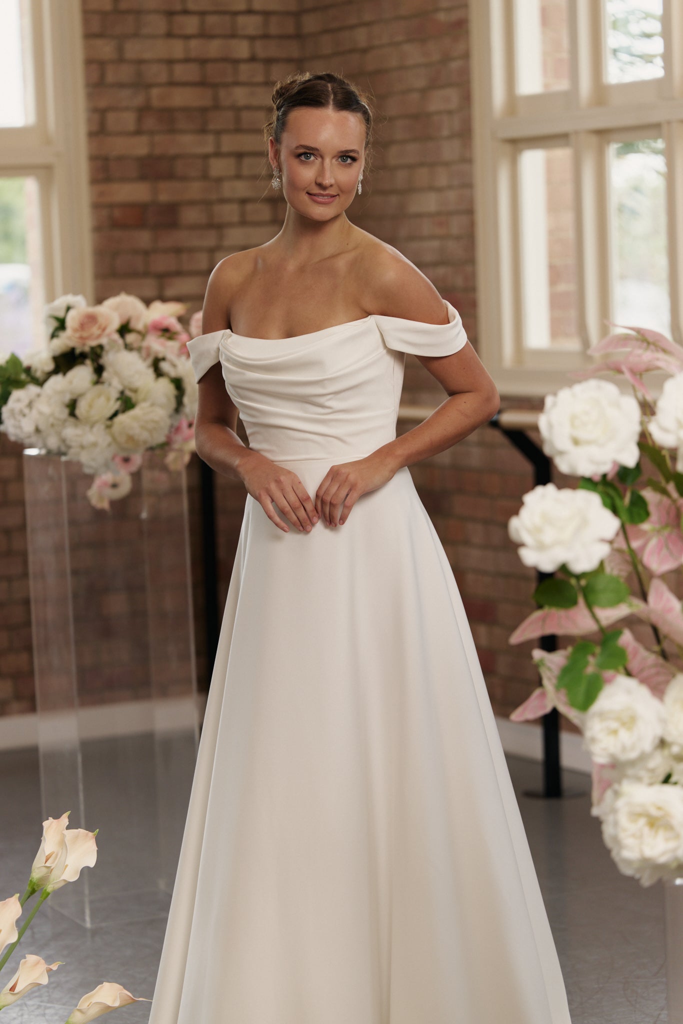 Close-up of Anne wedding gown showing ruched bodice and smooth crepe fabric.