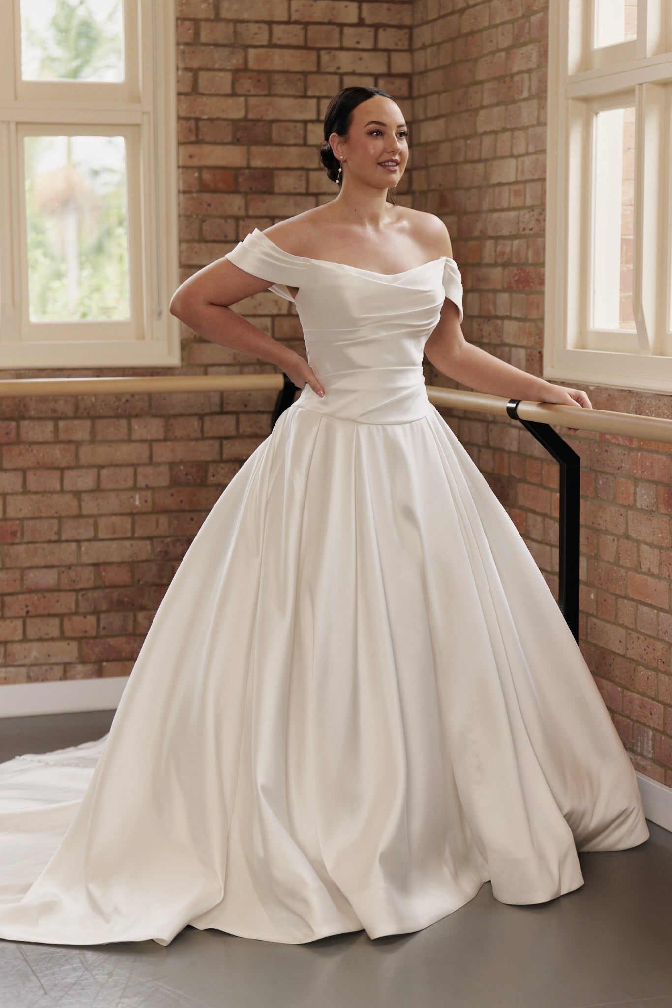 Bride wearing Antonia wedding gown with ruched corset bodice and full satin Mikado skirt.
