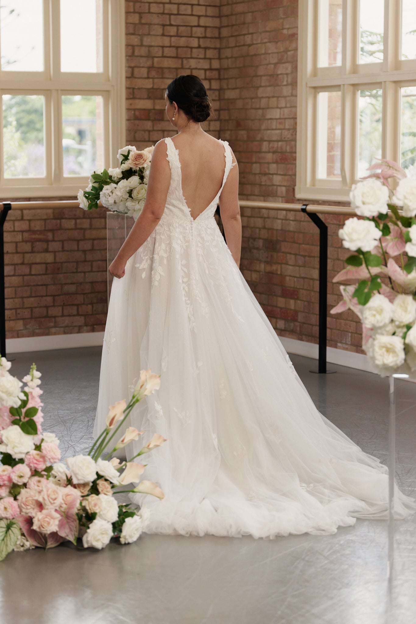 Back of Celine princess ball gown wedding dress with V-neck and embroidered detailing.
