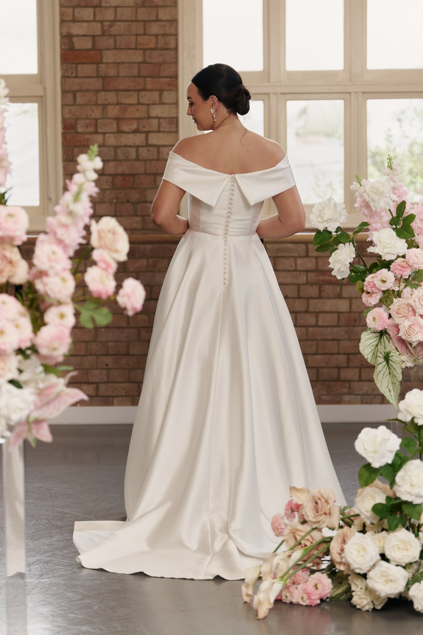 Back view of the Christie bridal gown showcasing the off-shoulder design and button down back.