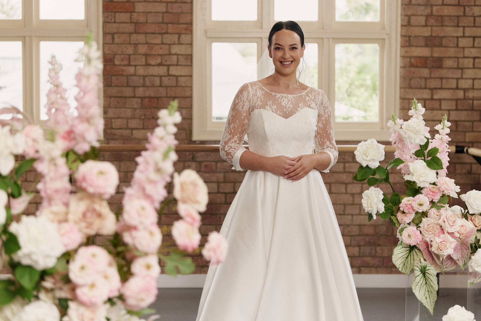 Close-up of the Elizabeth gown’s French Chantilly lace, silk texture, and elegant French cuff with button detail.