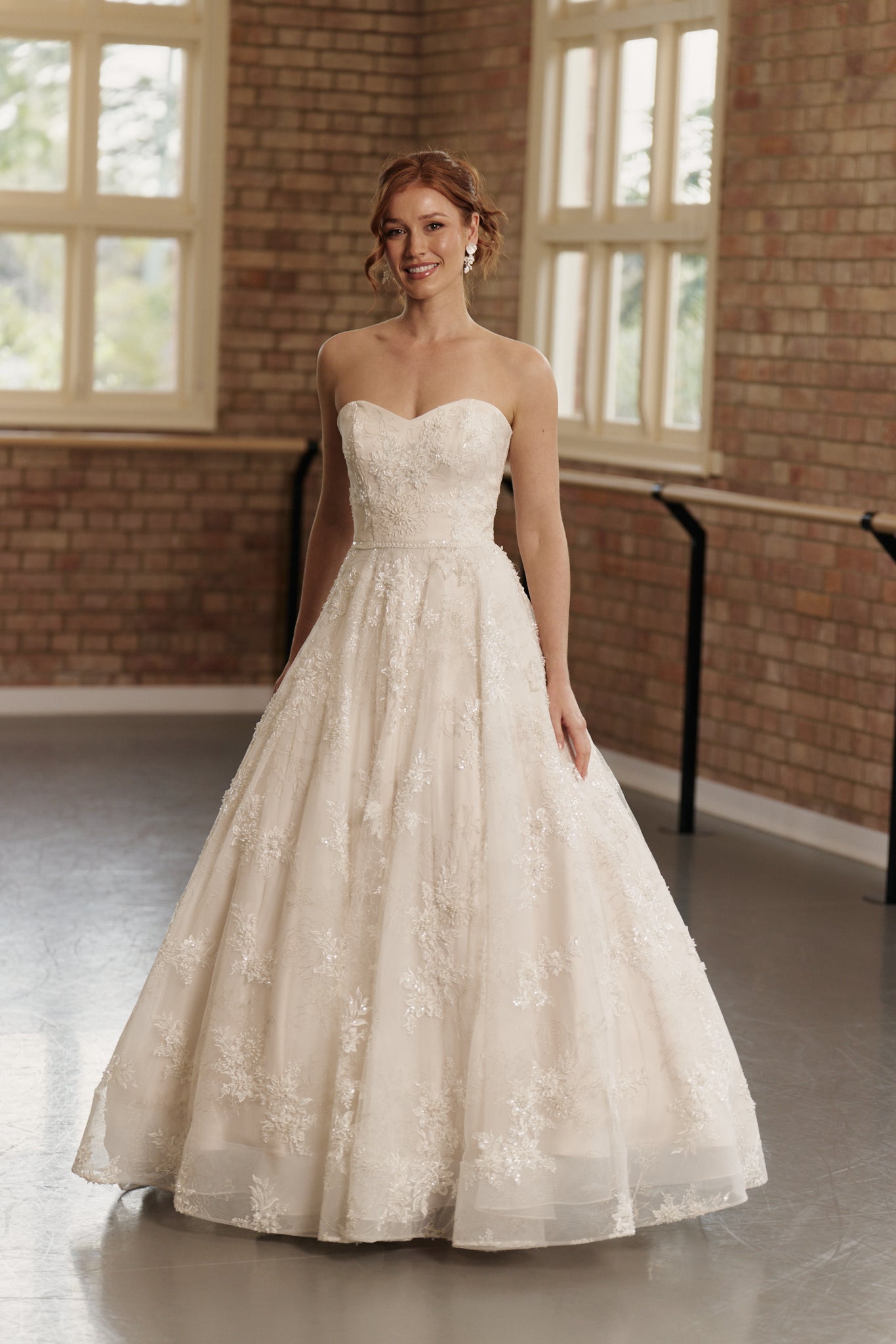 Front view of the Elodie wedding gown with strapless sweetheart neckline, intricate beading, and full princess ball gown skirt.