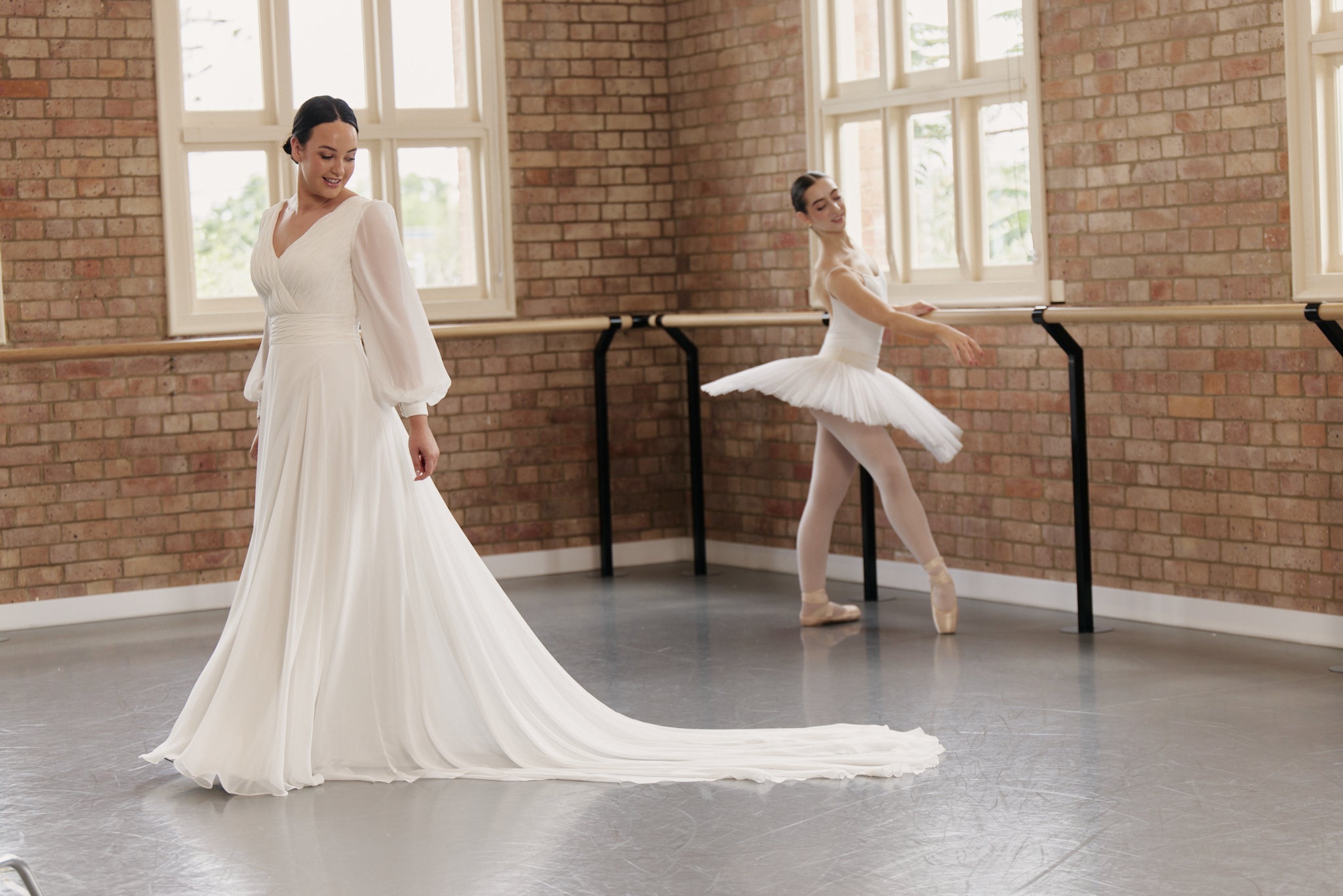 Side view of Kristen wrap wedding dress with finely pleated chiffon, bishop sleeves and flowing A-line skirt.