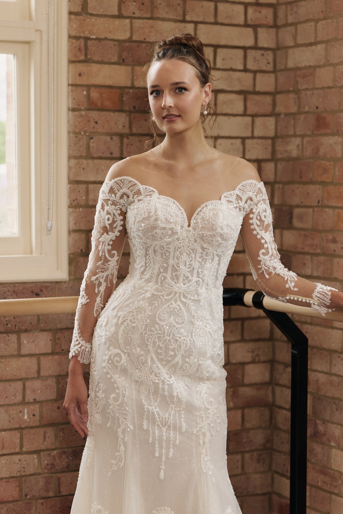 Labelle wedding dress with off-the-shoulder beaded sheer tulle sleeves, beaded lace bodice, and figure-hugging mermaid skirt.