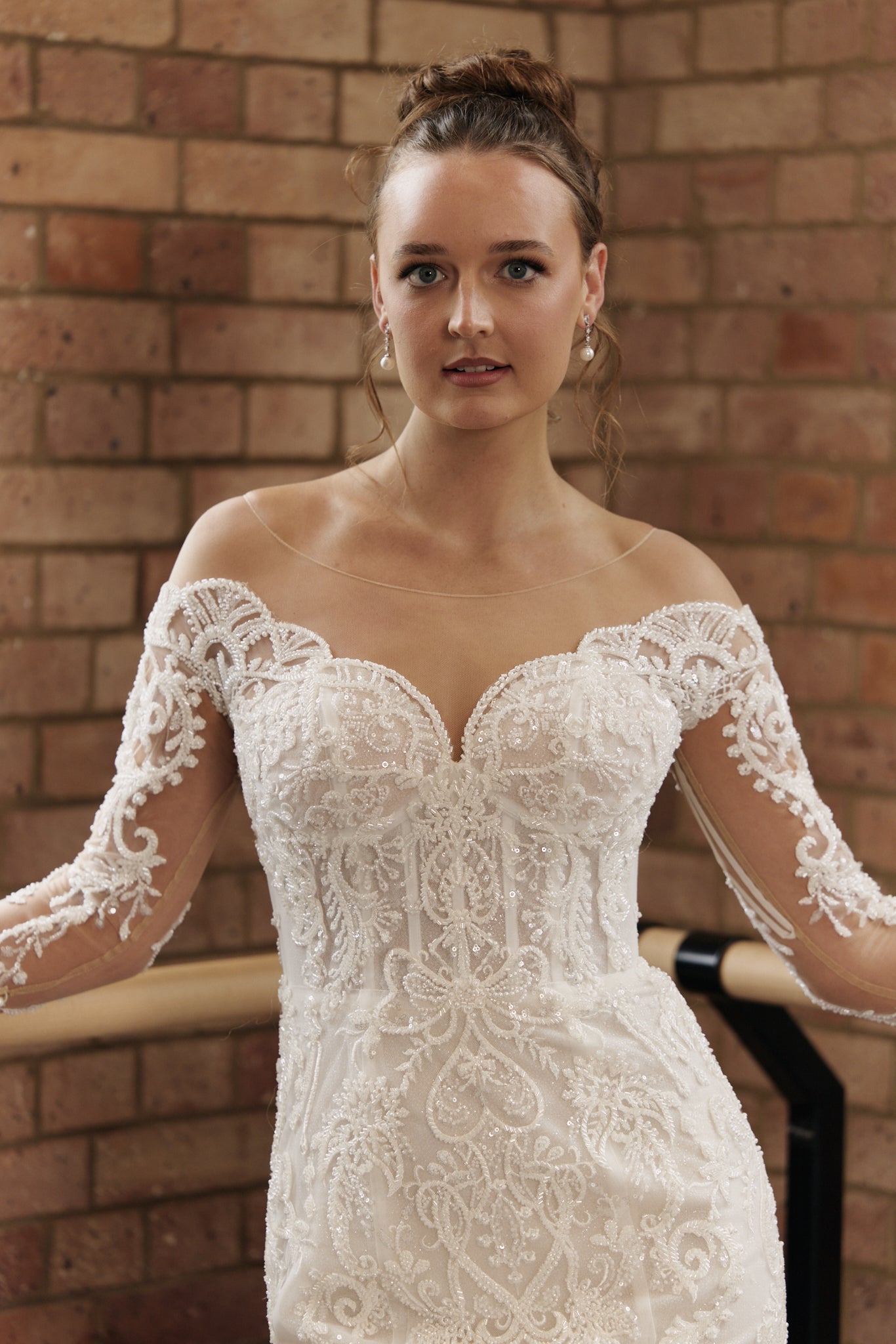 Close-up of beaded lace scalloped neckline, and sheer tulle sleeves.