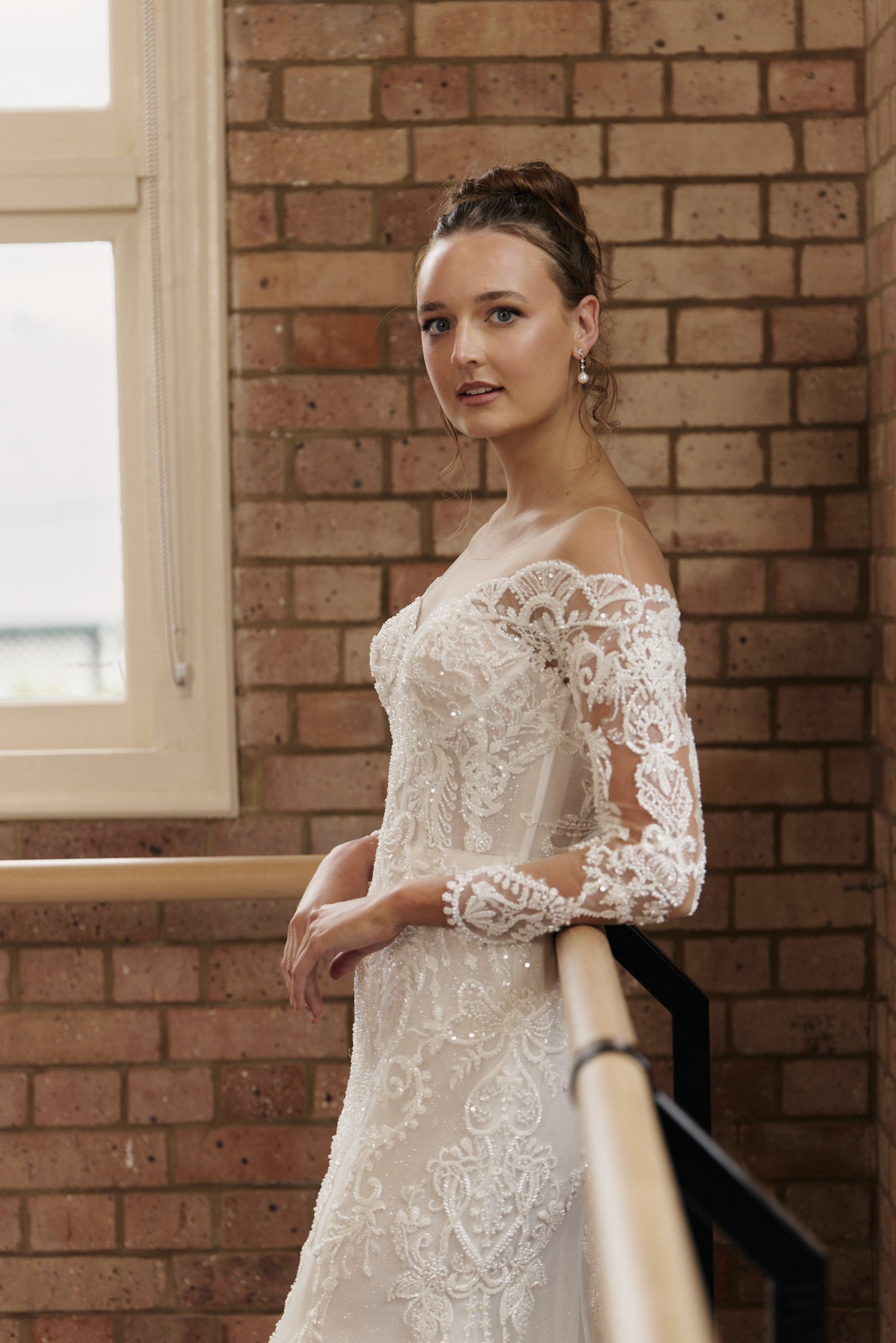 Side view of Labelle wedding dress with beaded tulle sleeves and flared mermaid skirt.