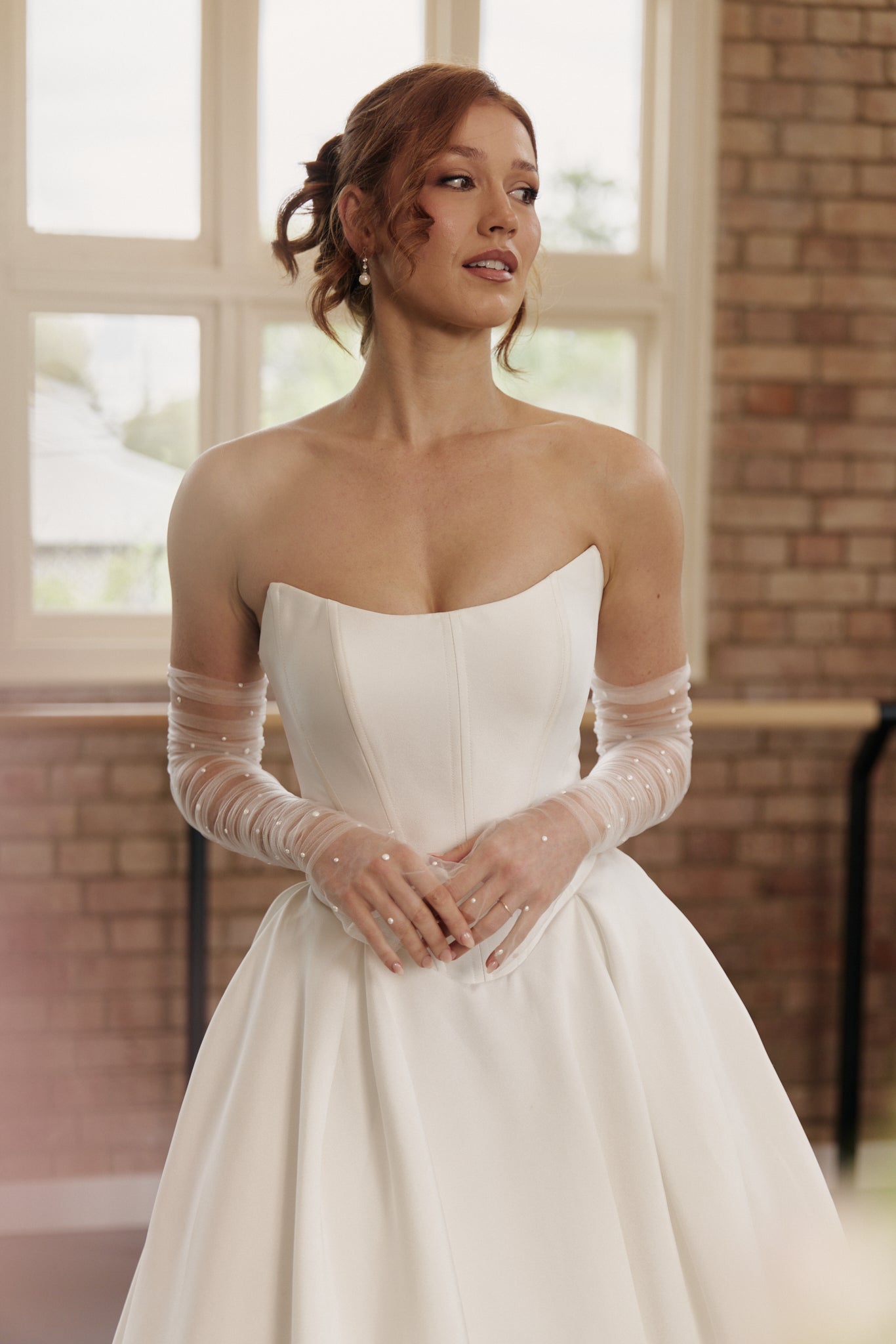 Close-up view of the Mackenzie bridal gown focusing on the soft scoop neckline and flattering basque waist design.