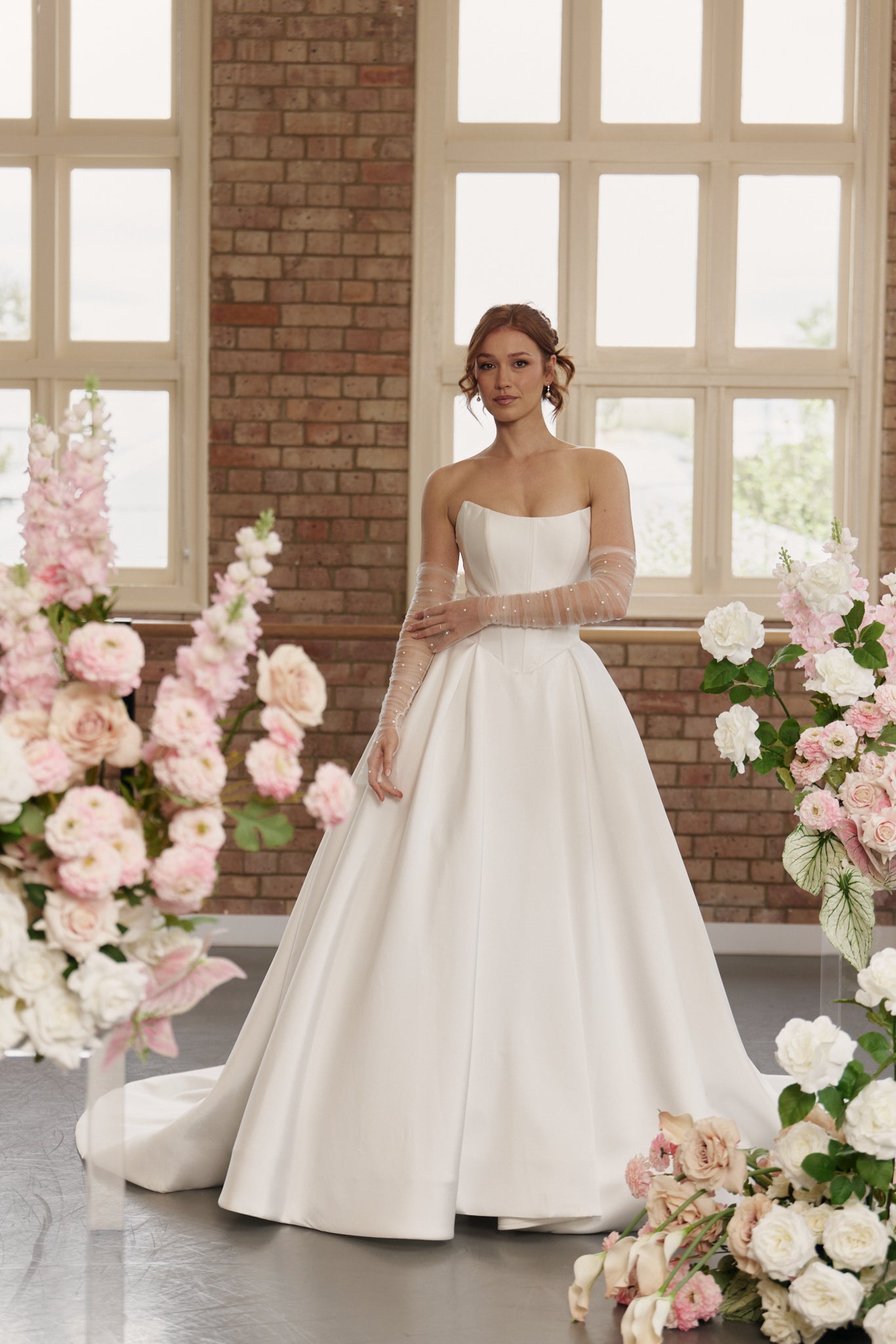 Romantic strapless ball gown wedding dress with a scoop neckline, basque waist, and structured corset