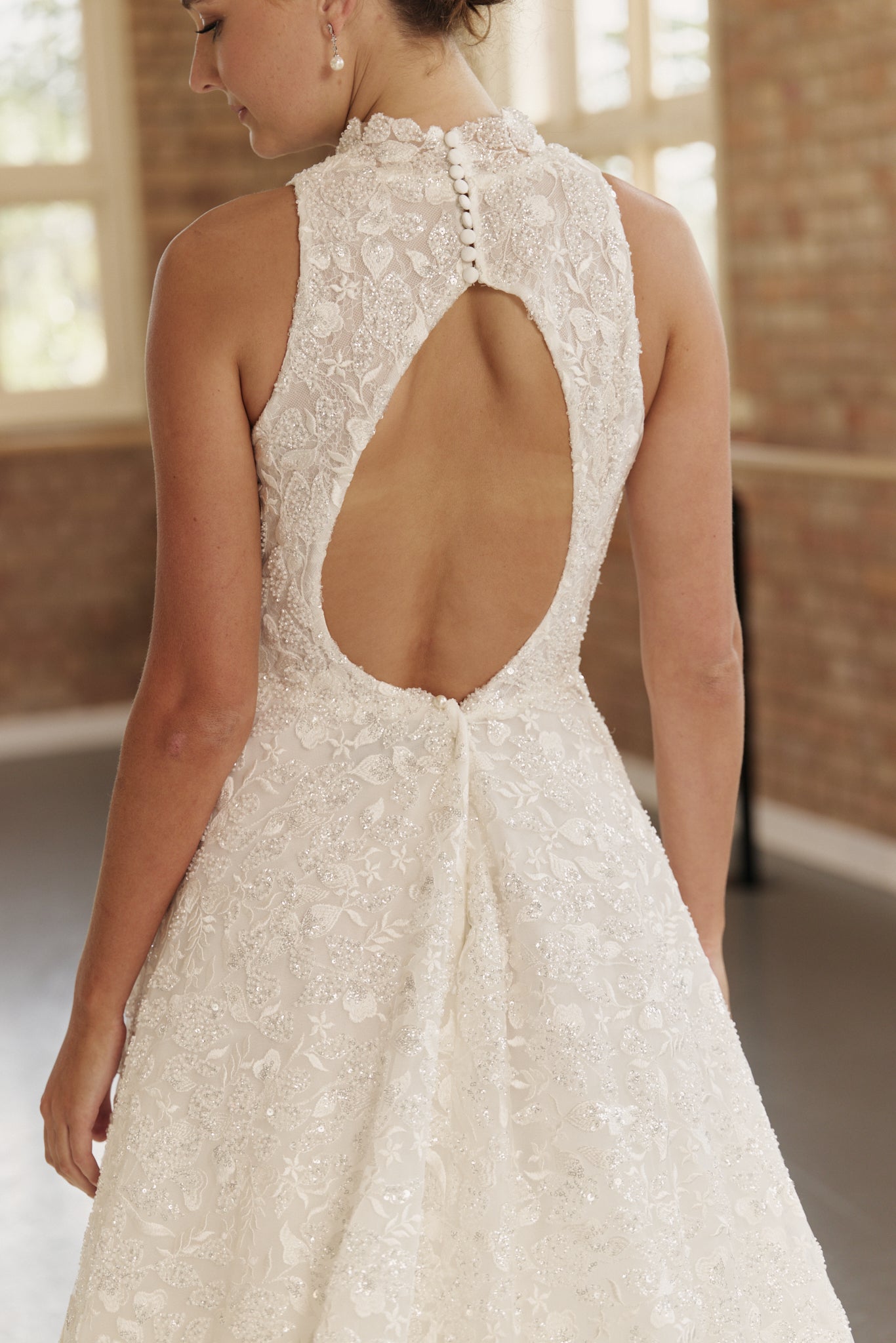 Close-up of the Mia dress' intricate beaded detailing, showcasing the open back and fine craftsmanship of the bodice