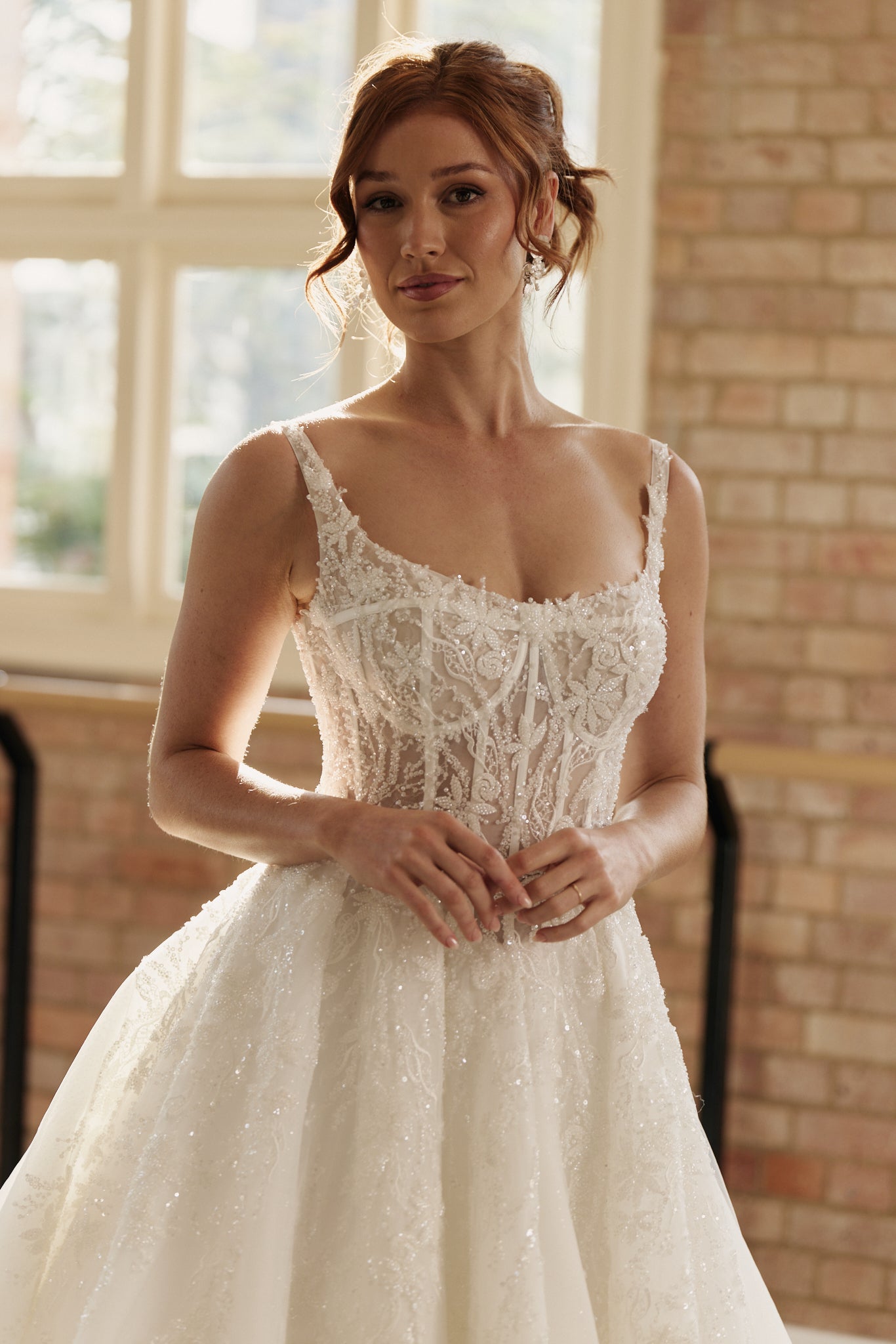 Close-up of Ophelia Wedding Dress corset bodice and delicate lace beading on layered organza fabric.