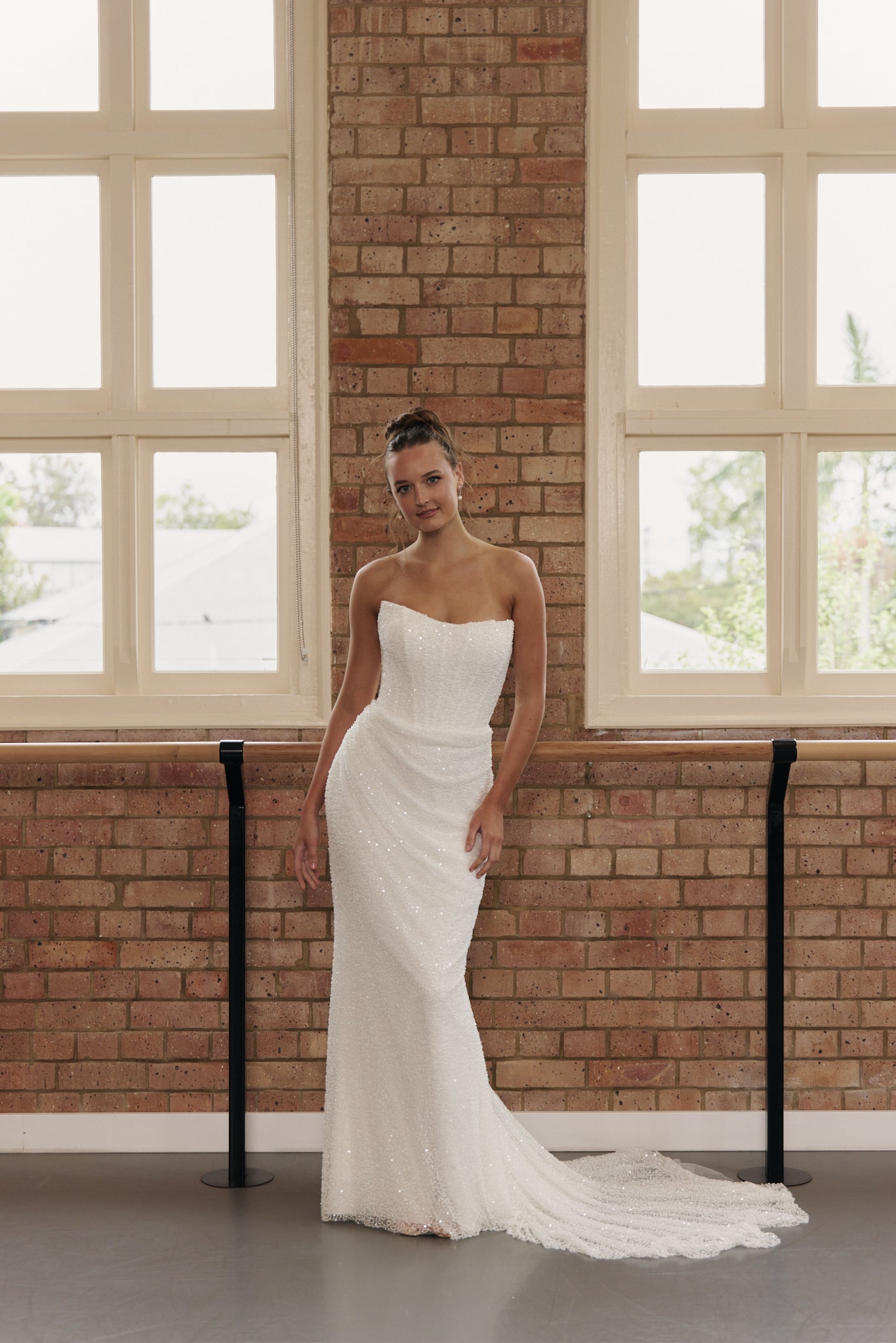 Front view of the Rebecca strapless fully beaded mermaid wedding gown with structured bodice, gentle ruching, and cats eye neckline.