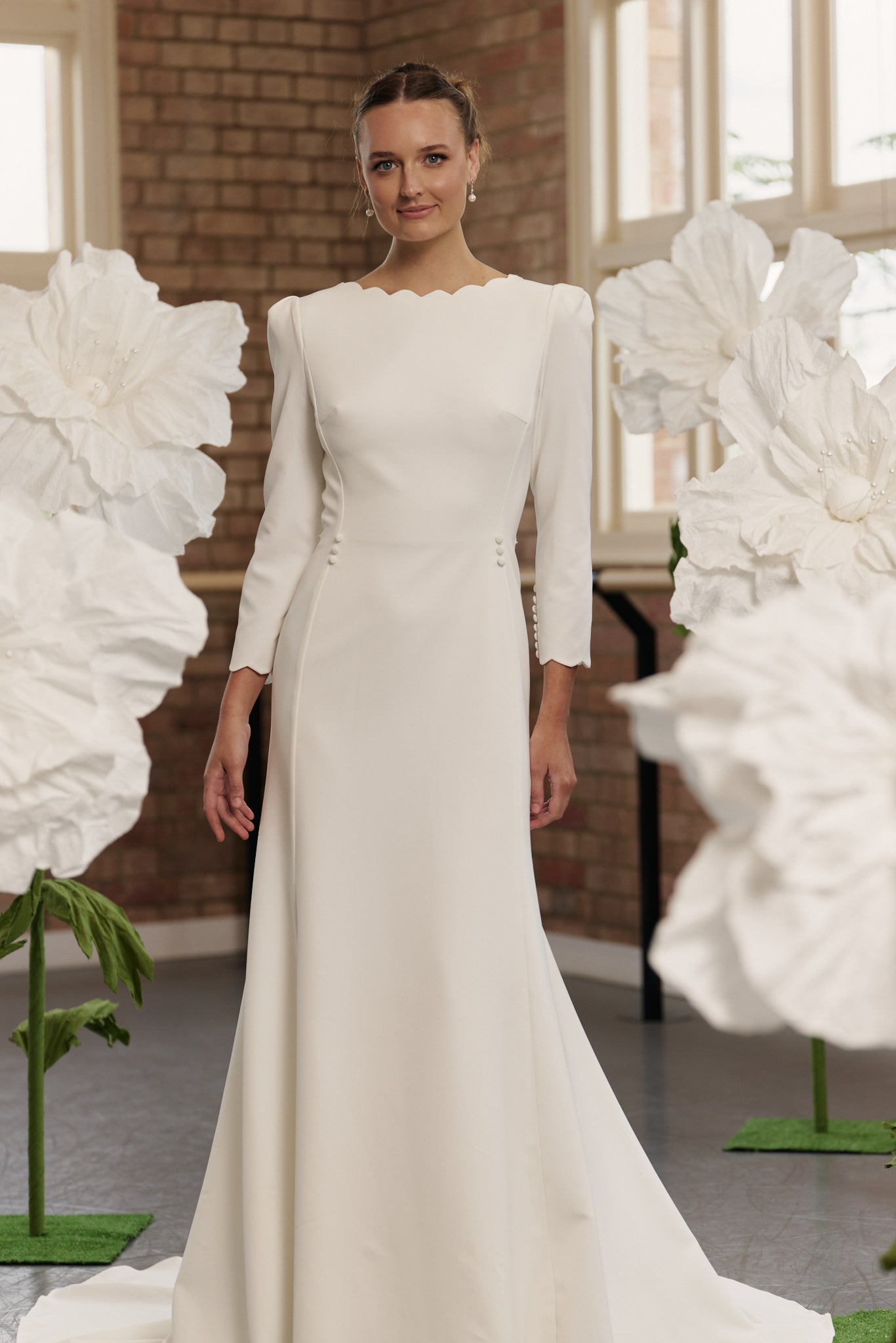 Front view of the Shari wedding gown with scalloped boat neckline, 3/4 sleeves, and fitted mermaid sheath skirt.