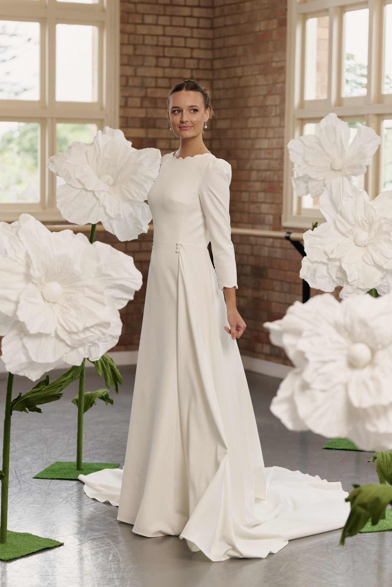 Side profile of the Shari gown highlighting fitted mermaid silhouette, 3/4 sleeves, and optional full overskirt.