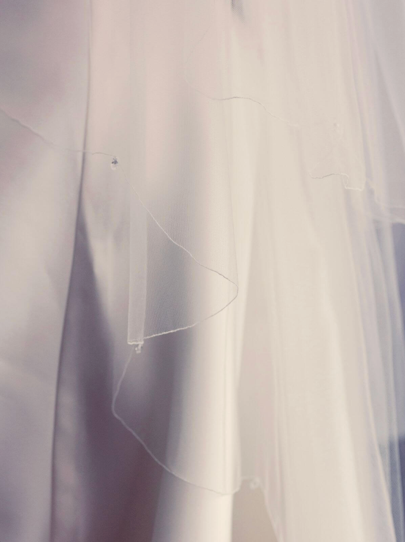 Close up of Crystal Drops on scalloped rolled edge of Delilah Bridal Veil