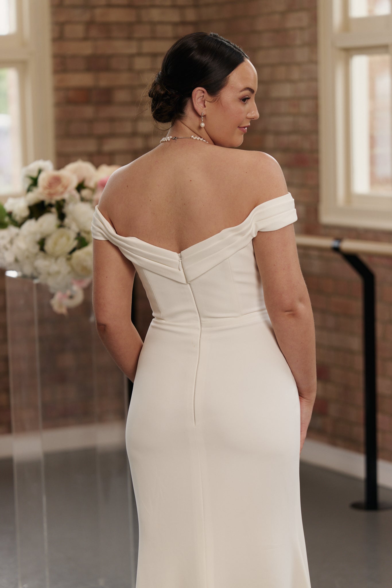 Violet bridal gown with flattering mermaid cut, pleated detailing, and sleek minimalist design.