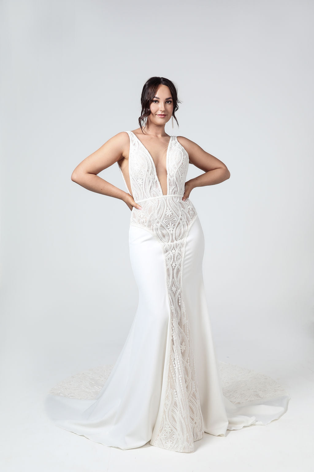 Front view of the Valentina wedding gown with deep V-neck, fully beaded geometric bodice, and fitted mermaid silhouette