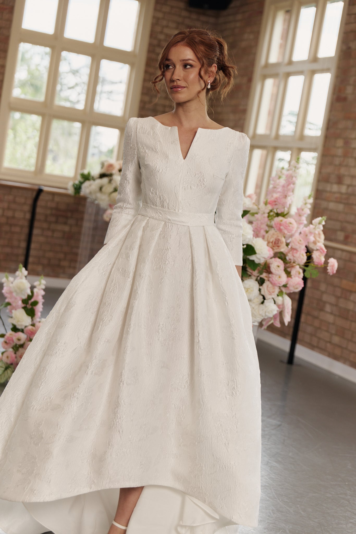 Andrea Wedding Dress with boat neck, 3/4 long sleeves, hi lo hemline, in jacquard