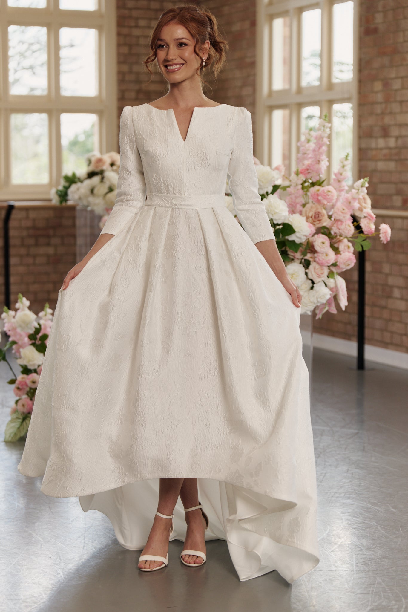 Andrea Wedding Dress with boat neck, 3/4 long sleeves, hi lo hemline, in jacquard, front view
