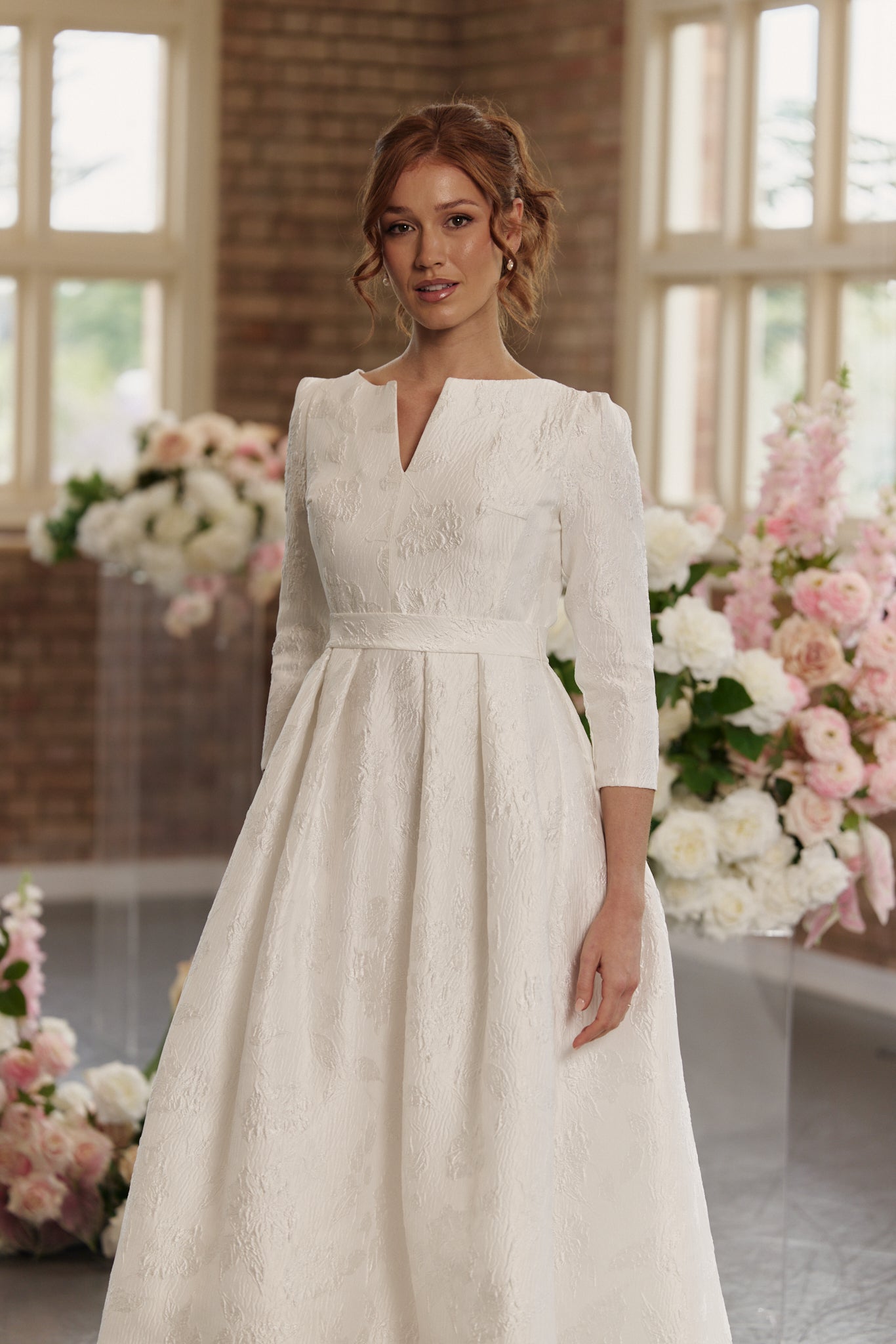 Andrea Wedding Dress with boat neck, 3/4 long sleeves, hi lo hemline, in jacquard, close up