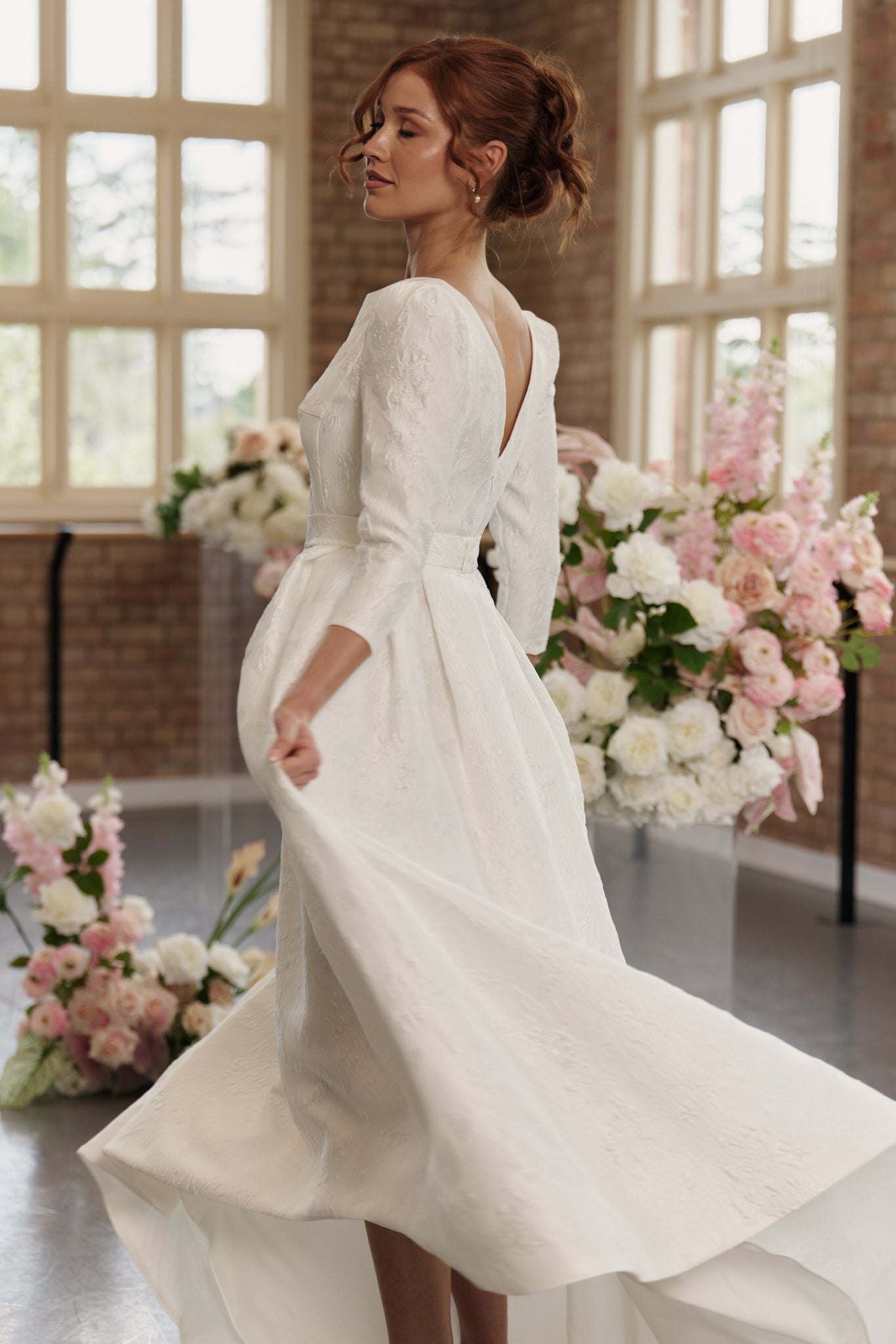 Andrea Wedding Dress with boat neck, 3/4 long sleeves, hi lo hemline, in jacquard, side view