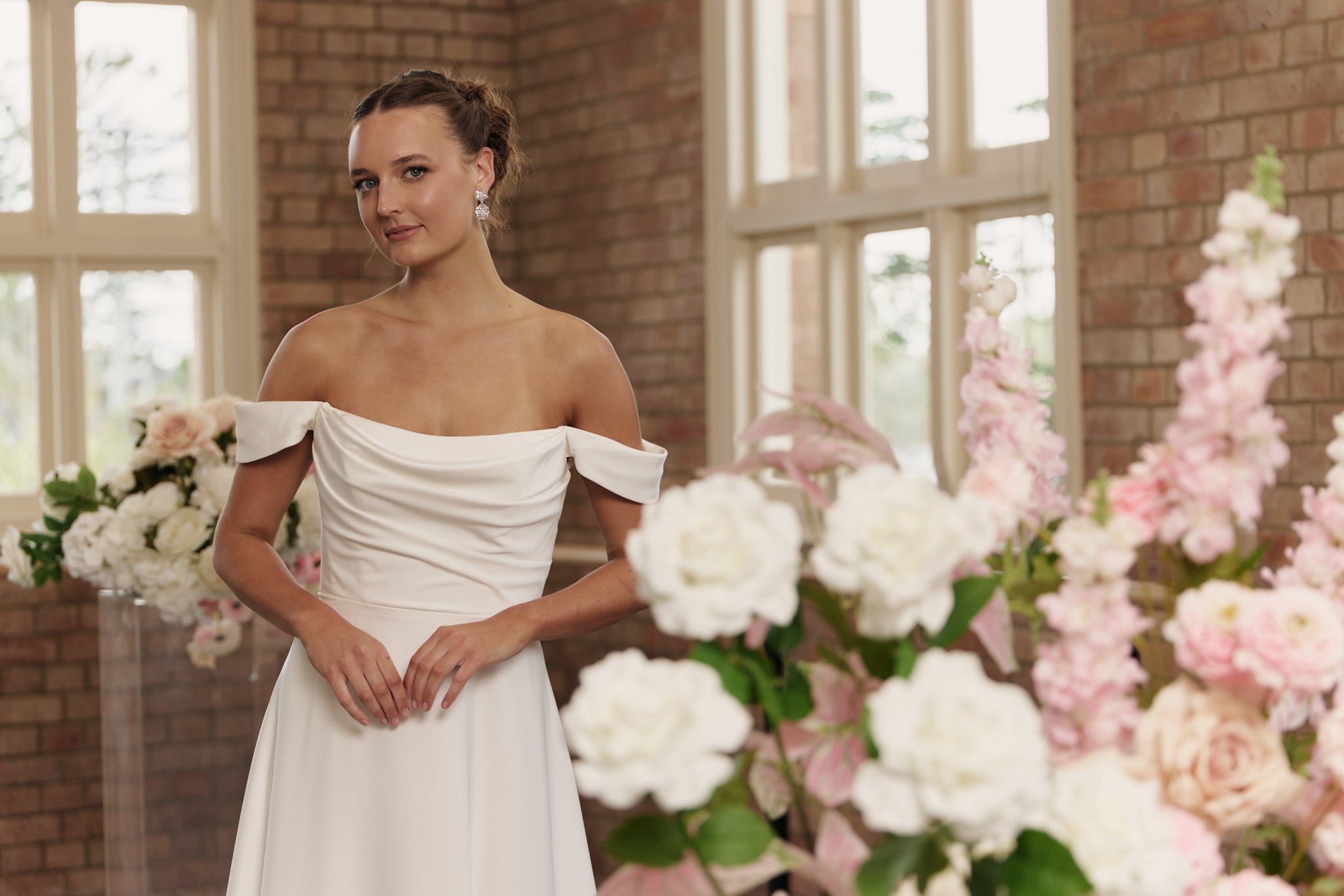 Anne wedding dress in crepe with softly ruched bodice and flowing A-line skirt.