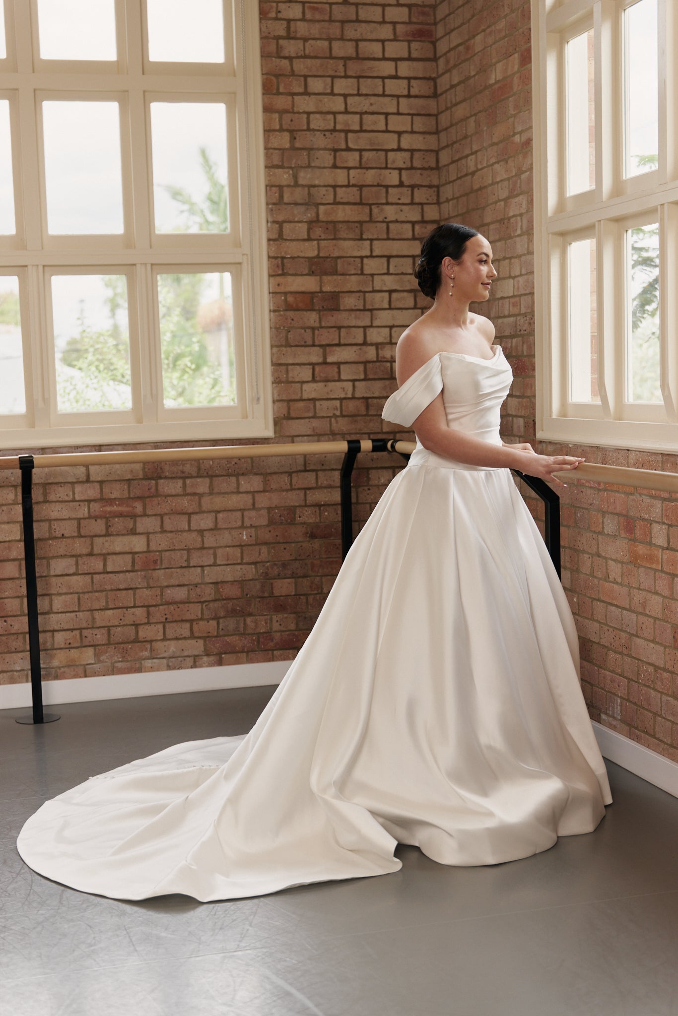 Antonia wedding dress with ruched structured corset bodice and full satin Mikado skirt, side view.