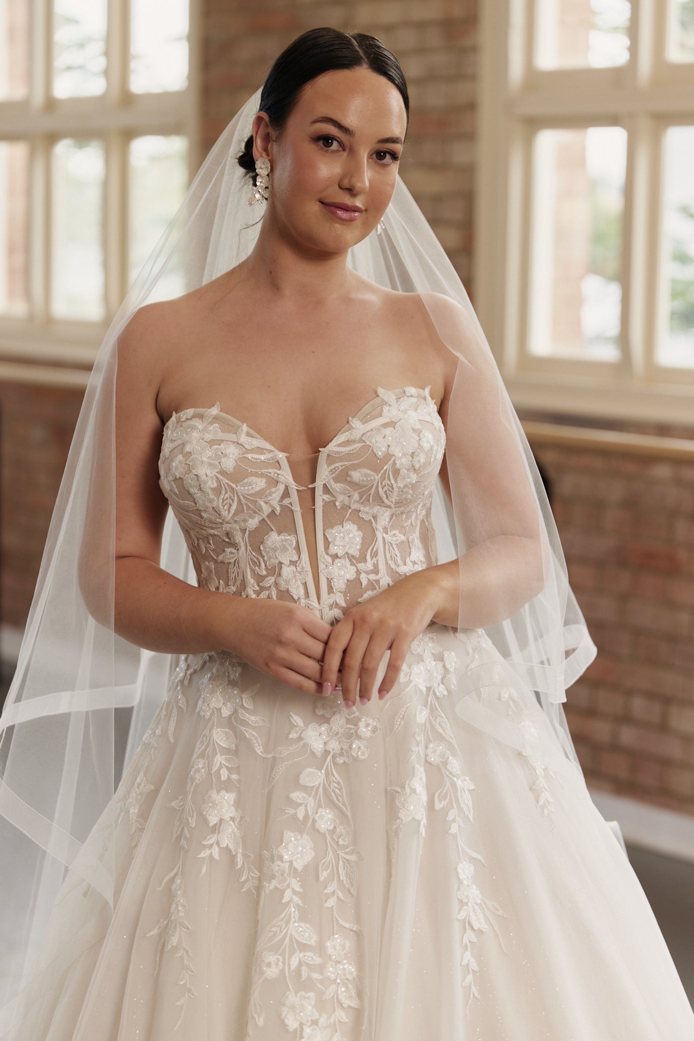 lose-up of the Camille gown’s strapless structured bodice and intricate embroidery on tulle skirt.