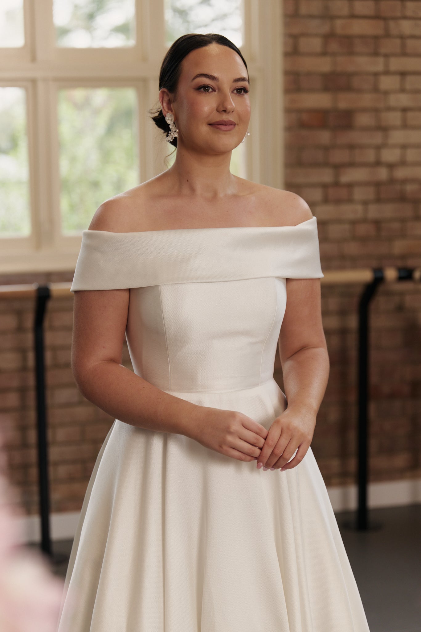 Close-up of the Christie gown’s finely textured jacquard fabric and elegant off-shoulder neckline