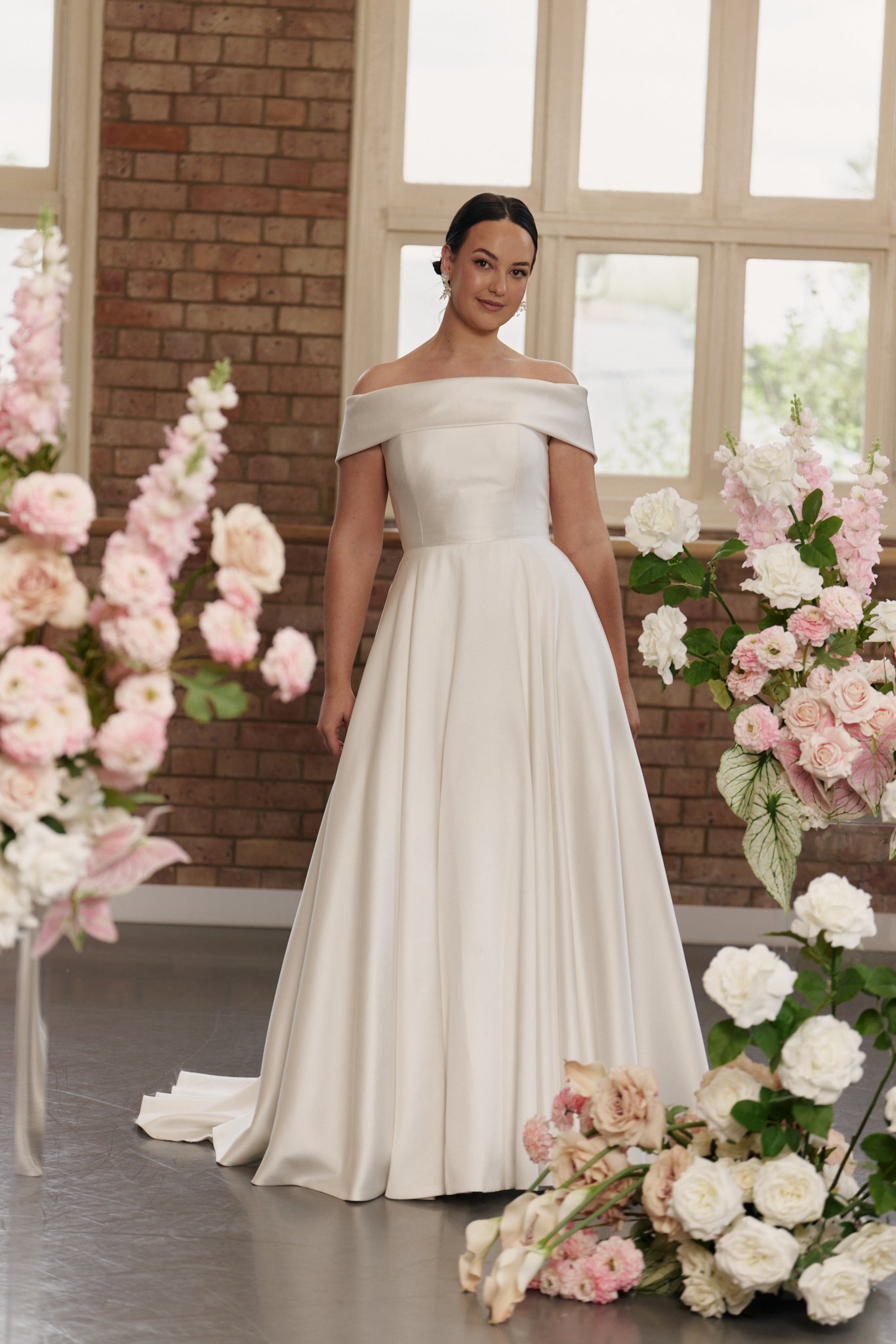 Front view of the Christie wedding dress in jacquard with off-shoulder neckline and full A-line skirt, offering a classic and elegant silhouette.