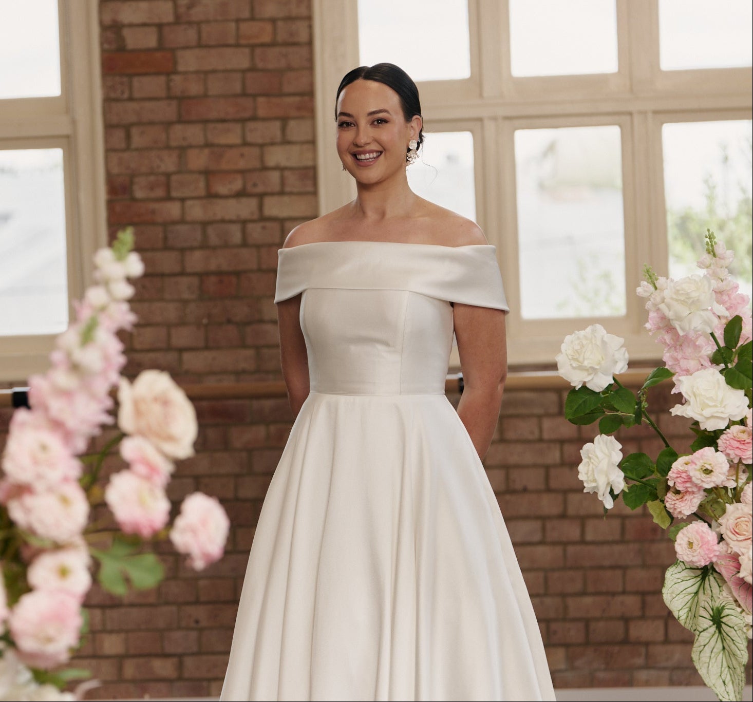 Timeless Christie bridal gown featuring off-shoulder neckline, flowing A-line skirt, and refined jacquard fabric