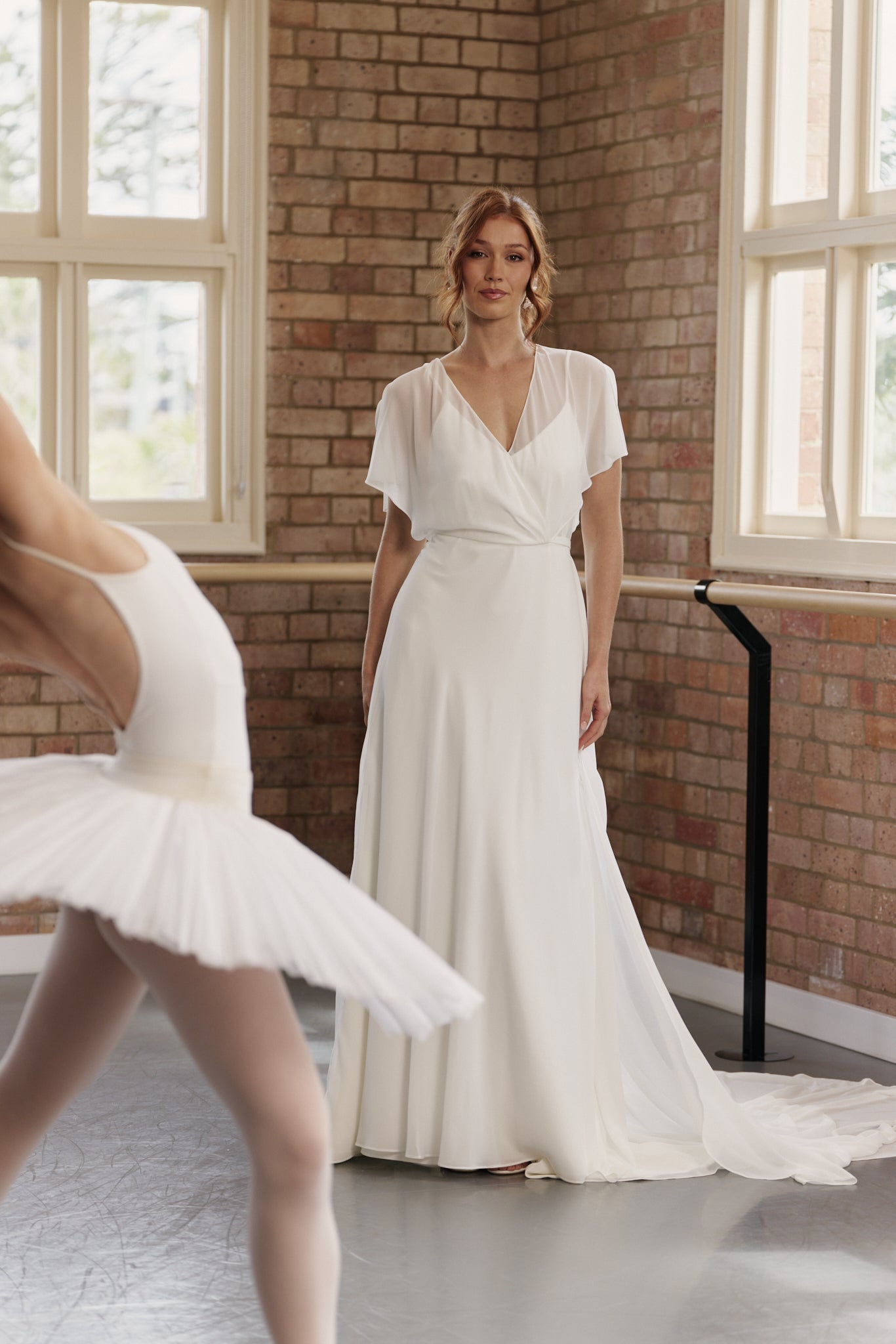 Clare wedding dress with flutter sleeves and flowing chiffon A-line skirt for a romantic, modern bridal look.