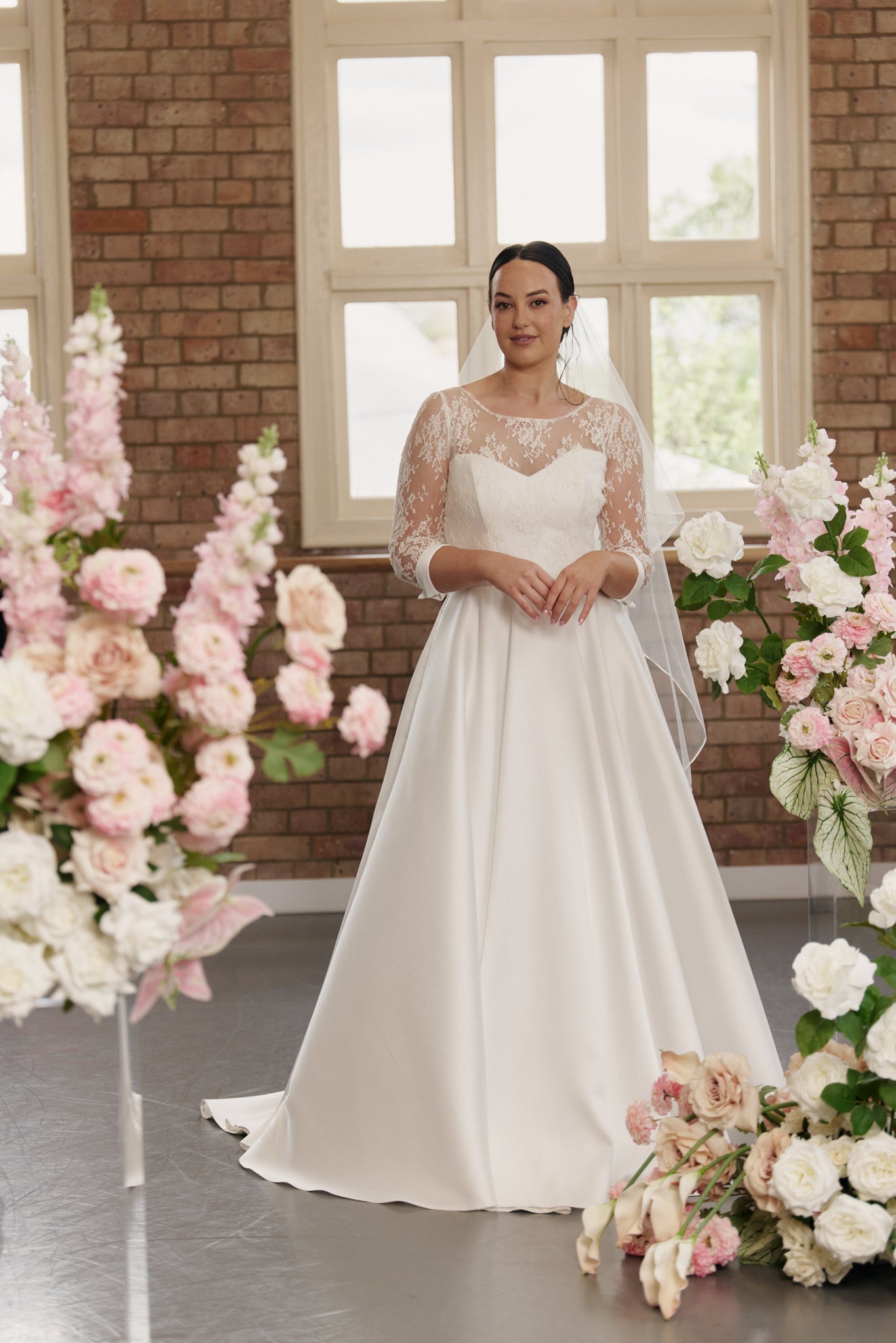 Front view of the Elizabeth wedding gown in French Chantilly lace and Italian silk with elegant cuffs and tailored detailing.