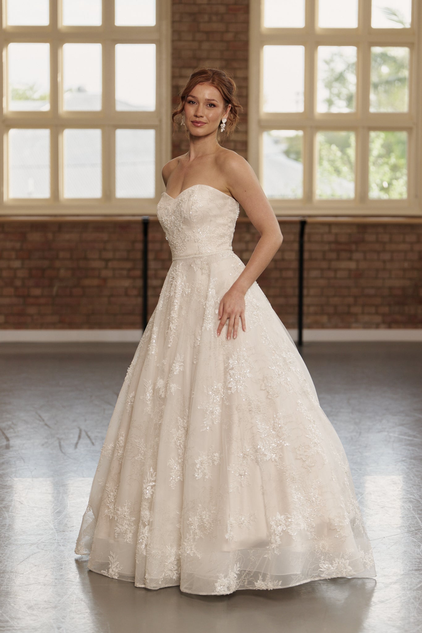 Side profile of the Elodie dress highlighting strapless sweetheart neckline, fitted beaded bodice, and flowing ball gown skirt.