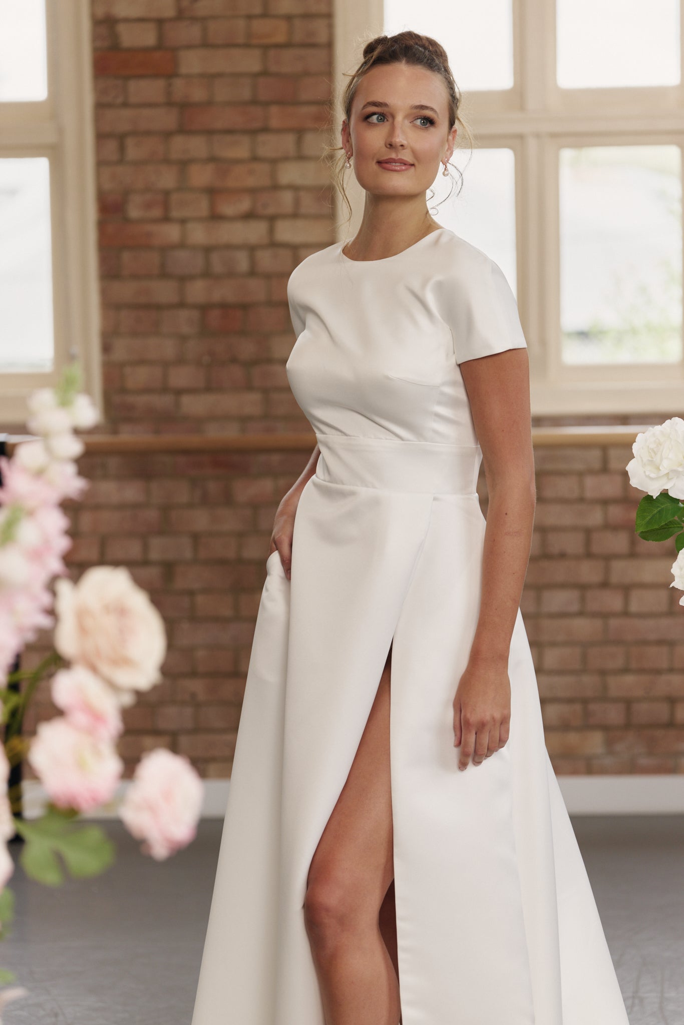 Close-up of waistband and short sleeves on Jane wedding dress with full skirt and split.