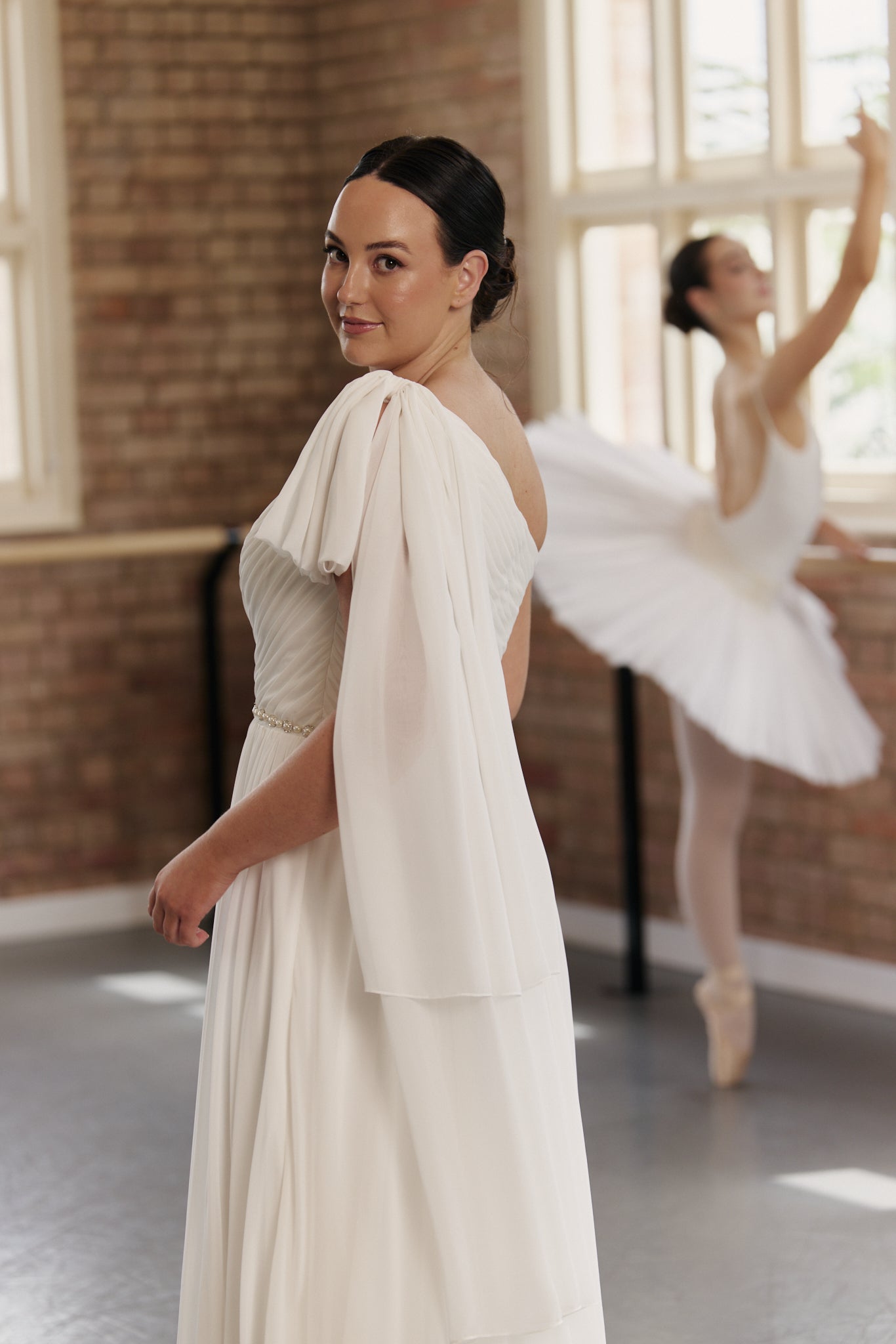 Side view of Kate wedding dress showing ruched one-shoulder bow chiffon design.