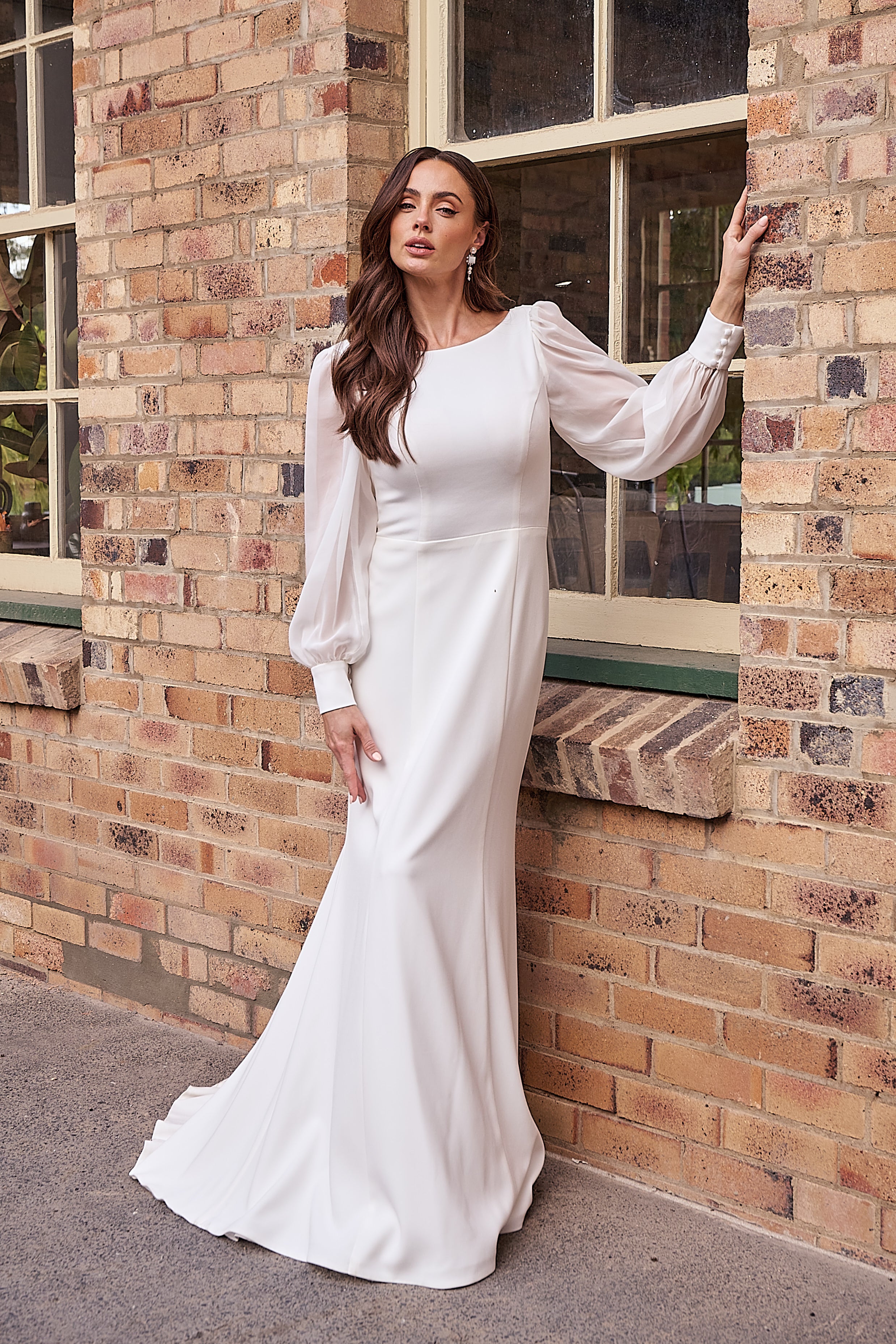 Elegant crepe wedding dress with boat neckline, flowing georgette sleeves, and straight silhouette