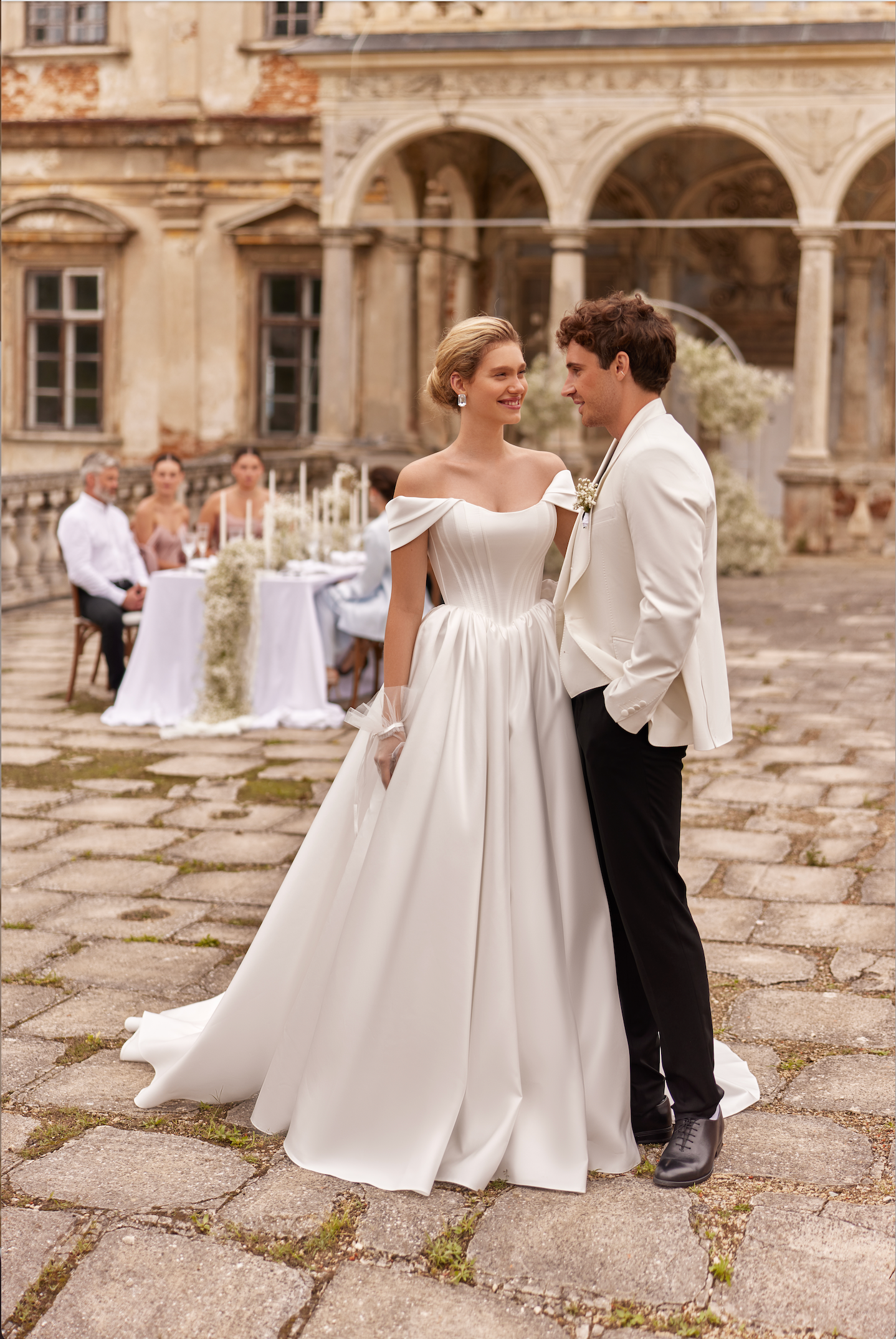 Lulu Wedding Gown with satin corset bodice and full skirt. Princess style, strapless with of the shoulder wing sleeves