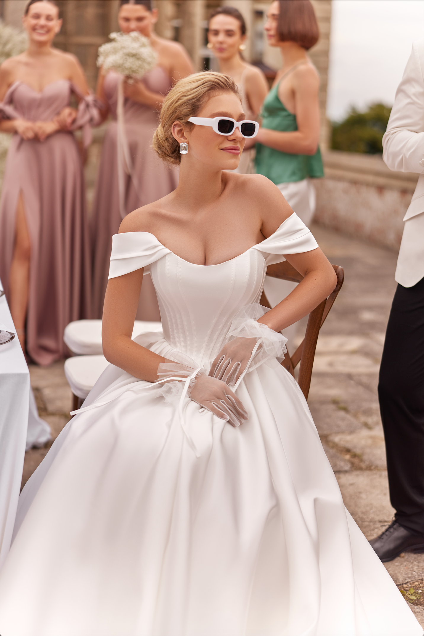 Lulu Wedding Gown with satin corset bodice and full skirt. Princess style, strapless with of the shoulder wing sleeves