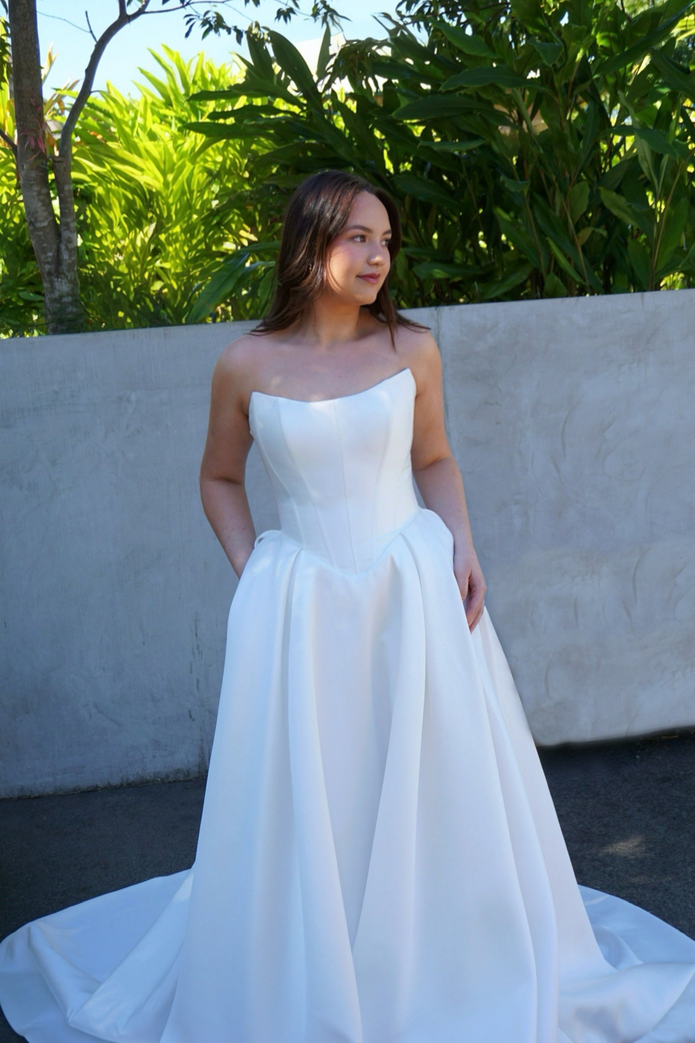 Princess ball gown Mackenzie wedding dress with strapless scoop neckline, corset bodice, and elegant basque waist.