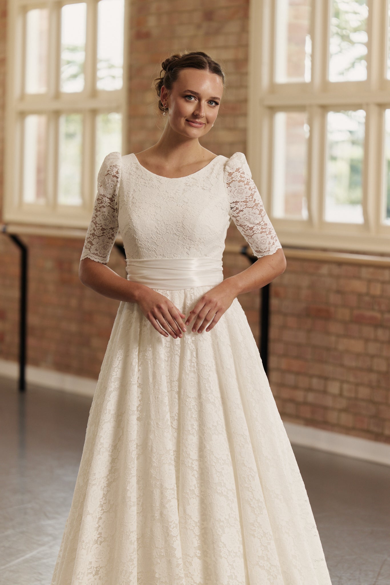 Close-up of the Roma gown’s lace detailing and ruched silk waistband, emphasizing refined craftsmanship.