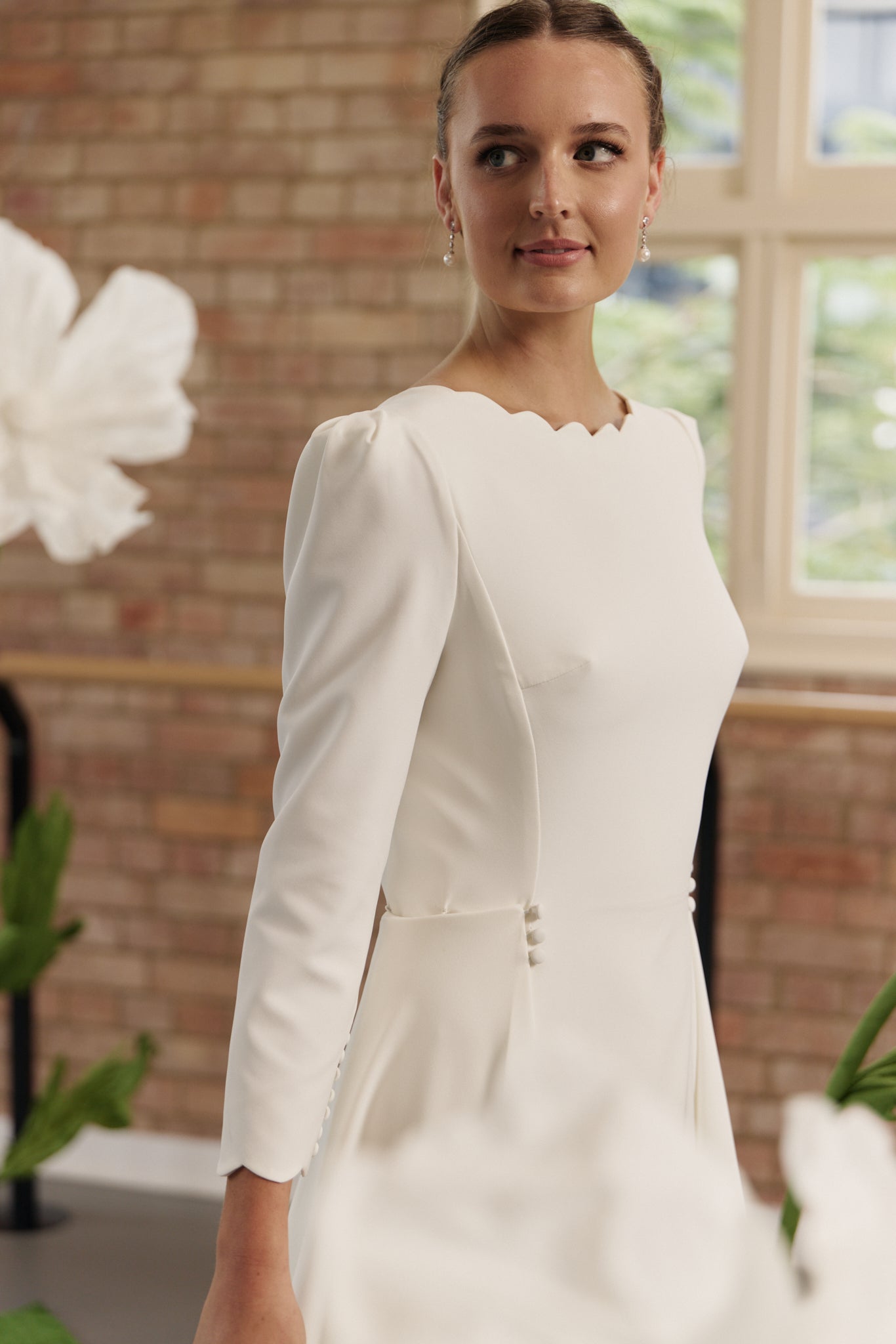 Elegant Shari wedding dress with scalloped boat neckline, low back and 3/4 sleeves.