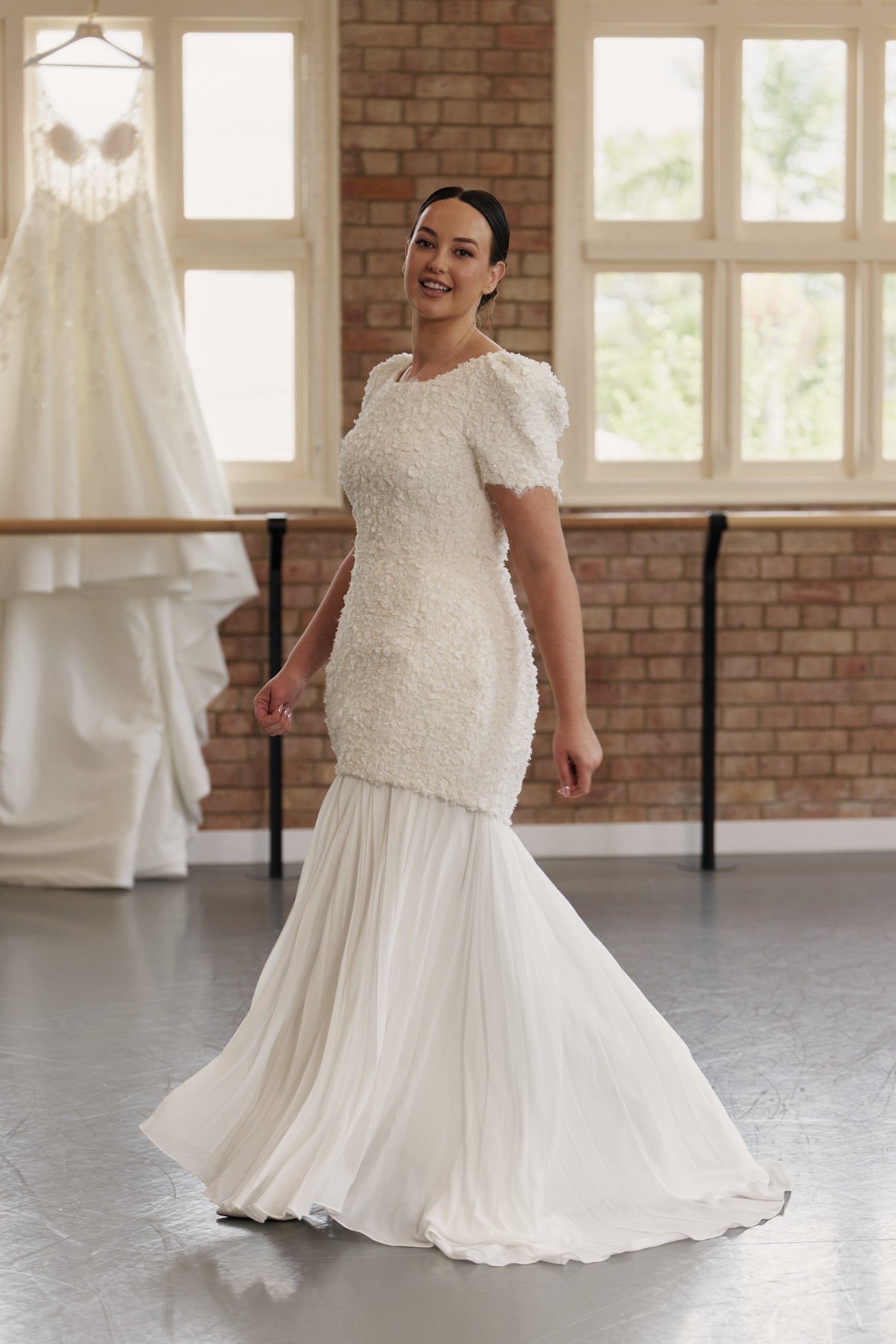Side profile of the Sunray Pleated Chiffon Skirt showing flowing silhouette and versatile styling.