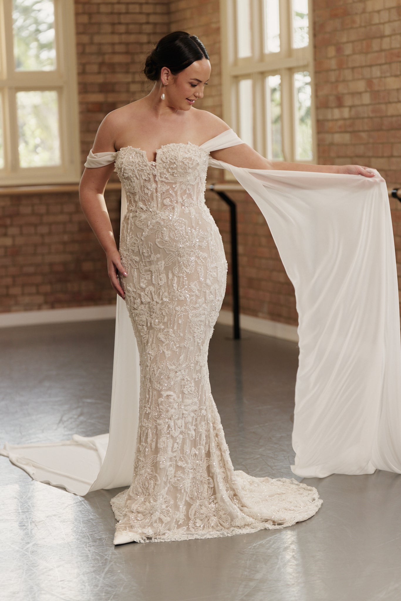 Statement bridal dress with off-shoulder design, beaded detailing, and ethereal georgette wings.