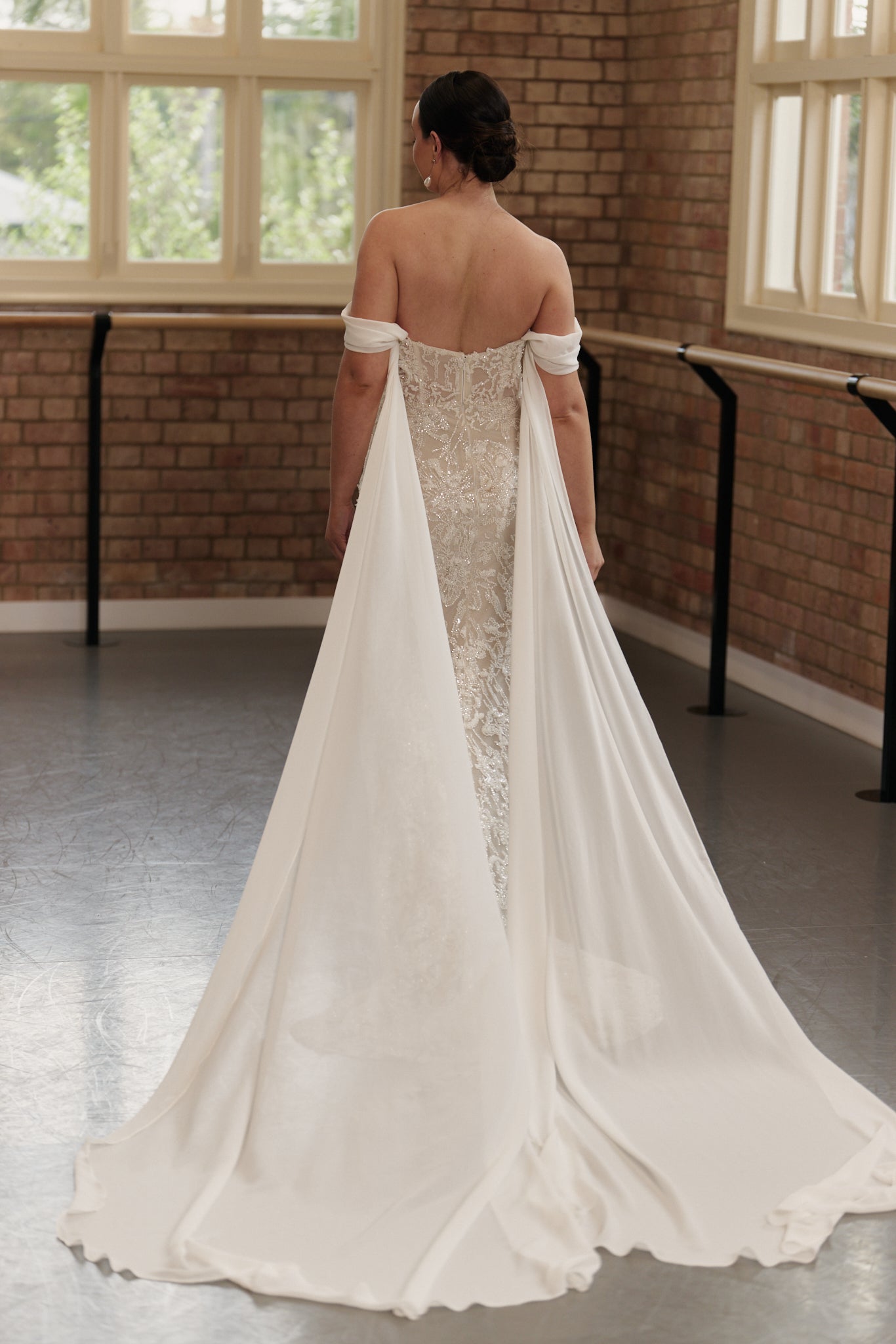 Statement bridal dress with off-shoulder design, beaded detailing, and ethereal georgette wings.