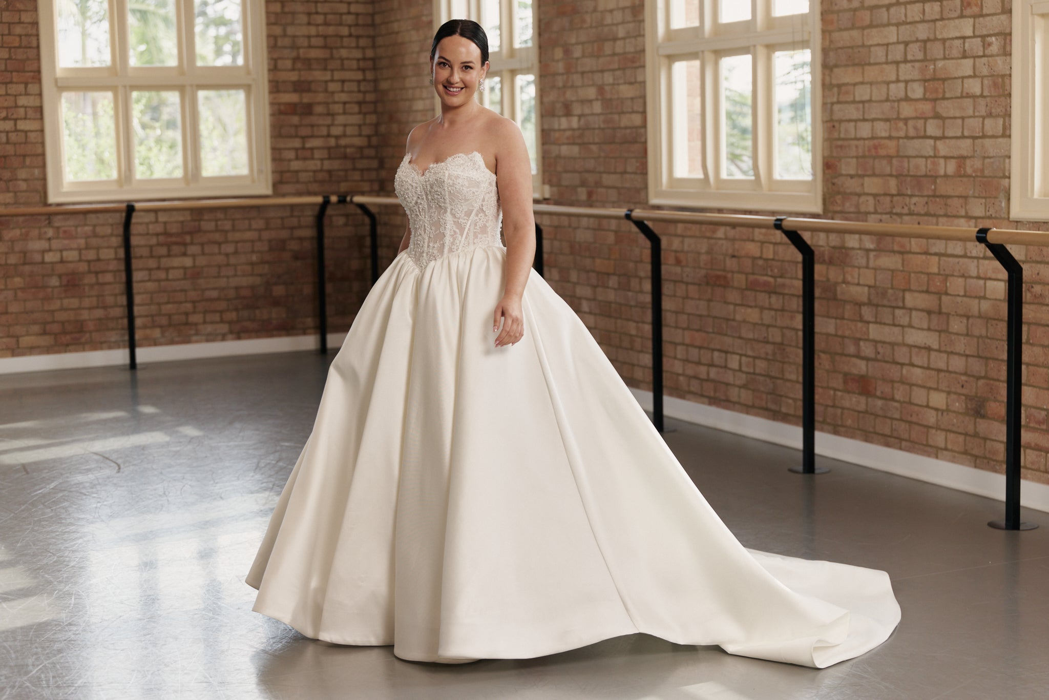 Fairytale ball gown with embellished lace bodice, structured support, and full flowing skirt for modern brides.