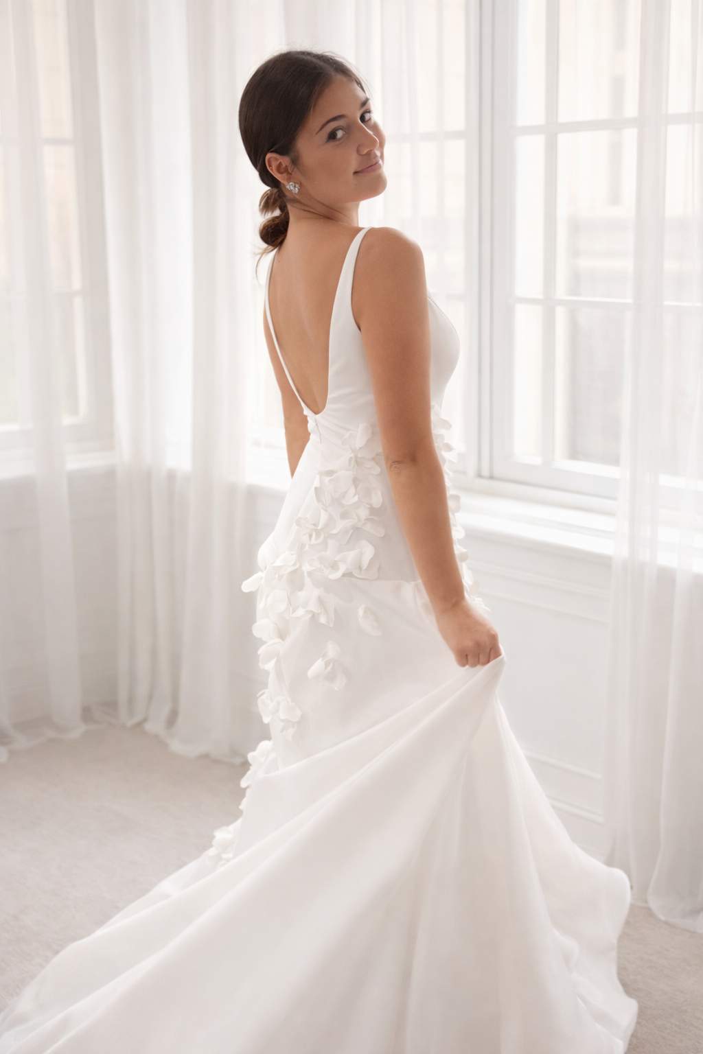 Minimalist wedding gown featuring 3D petals and clean lines